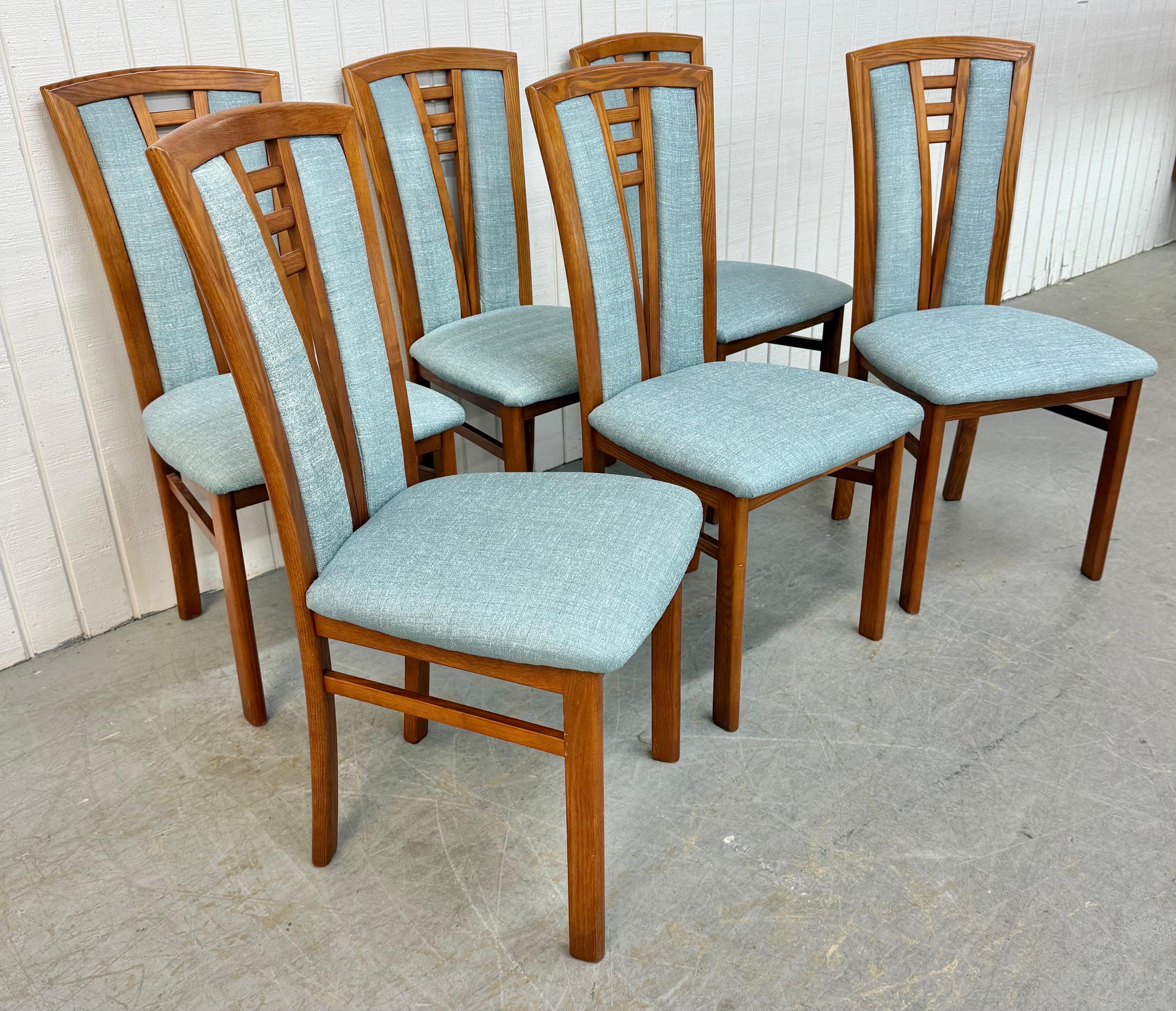 This listing is for a set of six Vintage Danish Modern Dining Chairs. Featuring a high back design, six side chairs, solid oak frames, and new blue upholstery. This is an exceptional combination of quality and Danish design! 