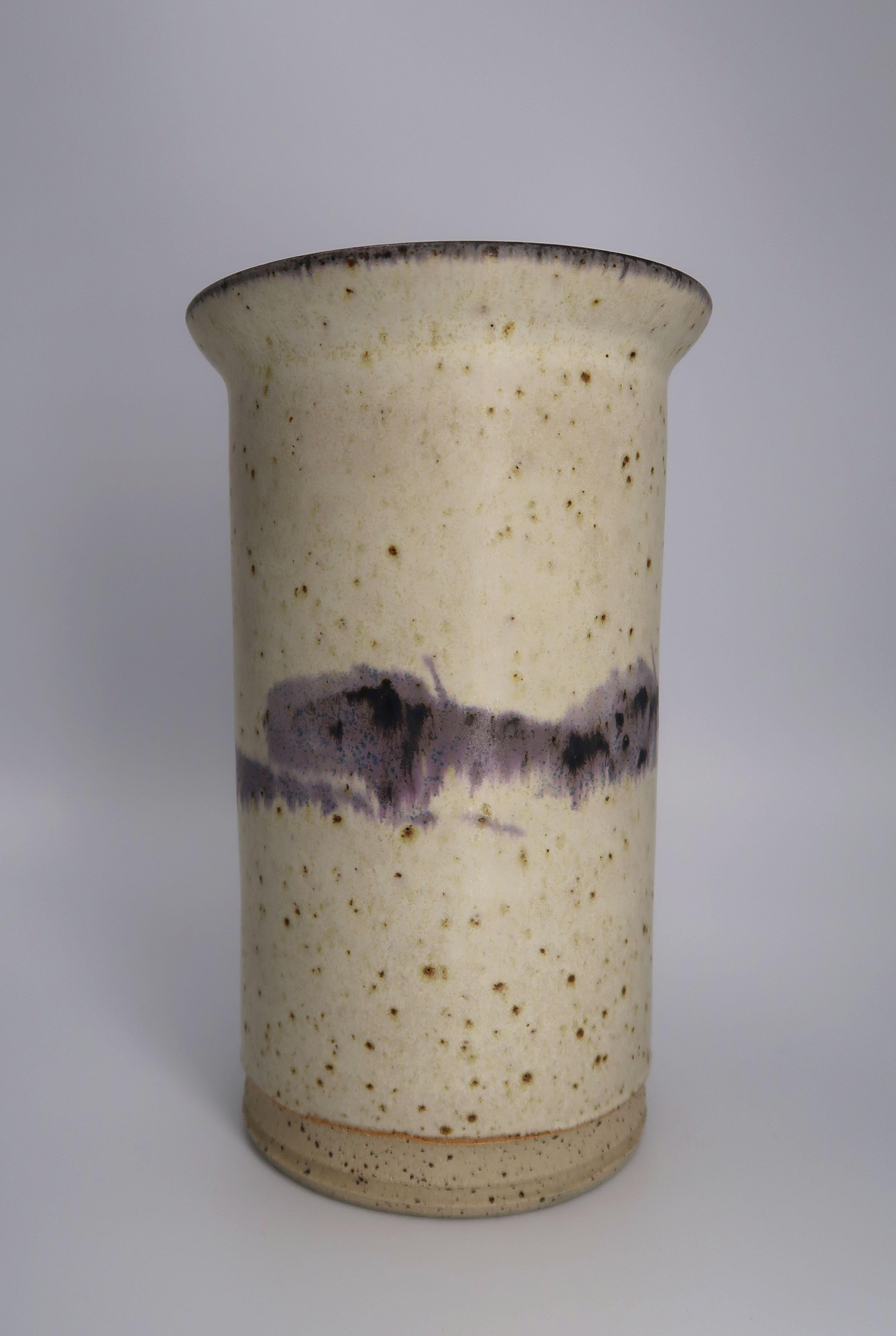 Cylinder shaped Danish modern handmade stoneware vase. Sand colored glaze with lilac and purple running glaze around belly and top. Signed under base. Beautiful vintage condition.
Denmark, 1970s. 