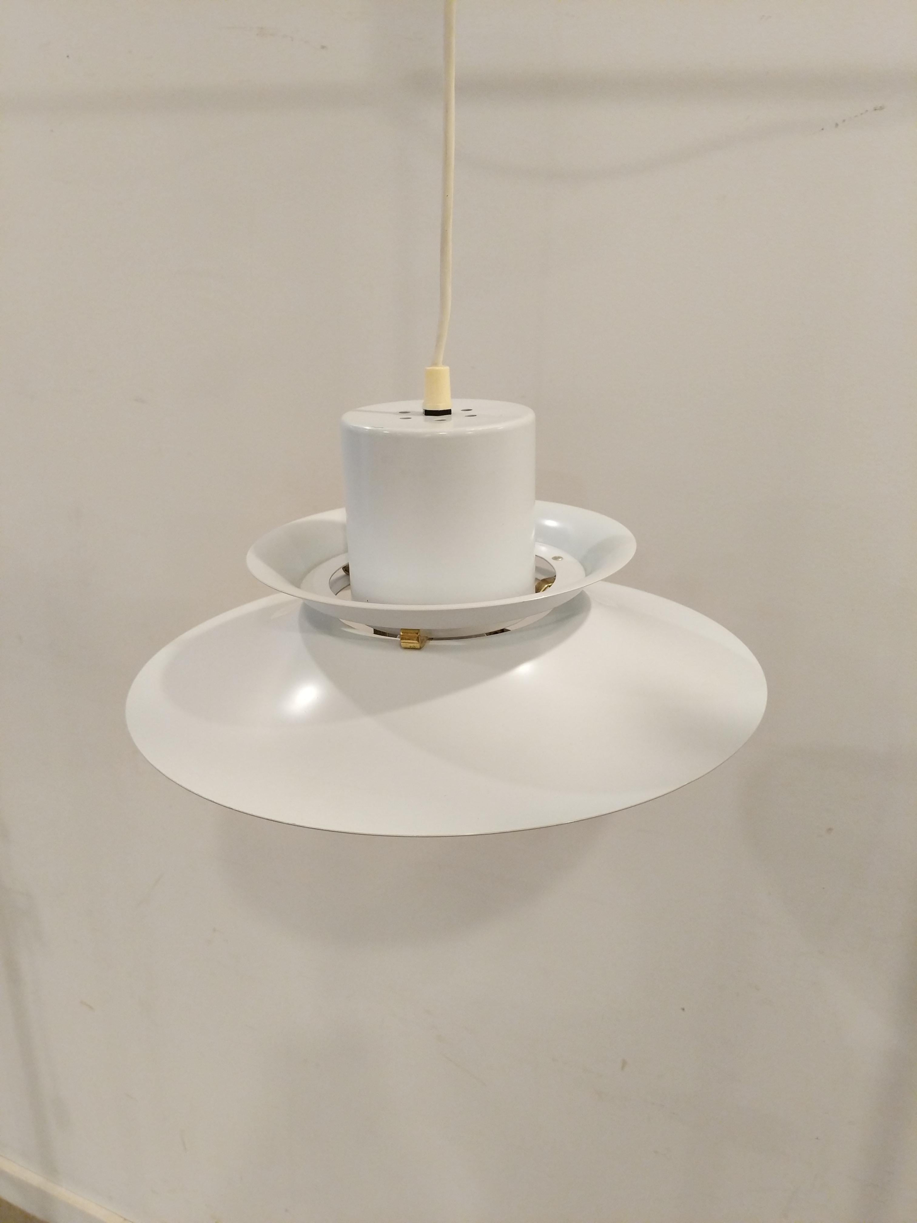 Authentic vintage mid century Danish / Scandinavian Modern hanging lamp / ceiling lamp / pendant light.

Imported directly from Denmark, this lamp is in great shape overall with minor wear from age (see photos).

The lamp is metal.

Dimensions:
14”