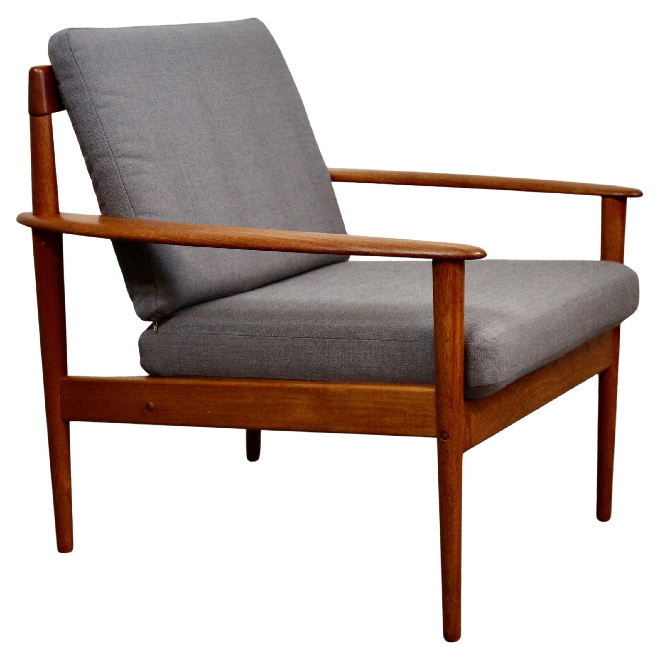 Bring home iconic mid-century modern furniture with this exquisite lounge chair produced by some of the greatest names in Danish woodworking. Designed by Grete Jalk and manufactured by the master craftsmen of Denmark's Poul Jensen Furniture, the