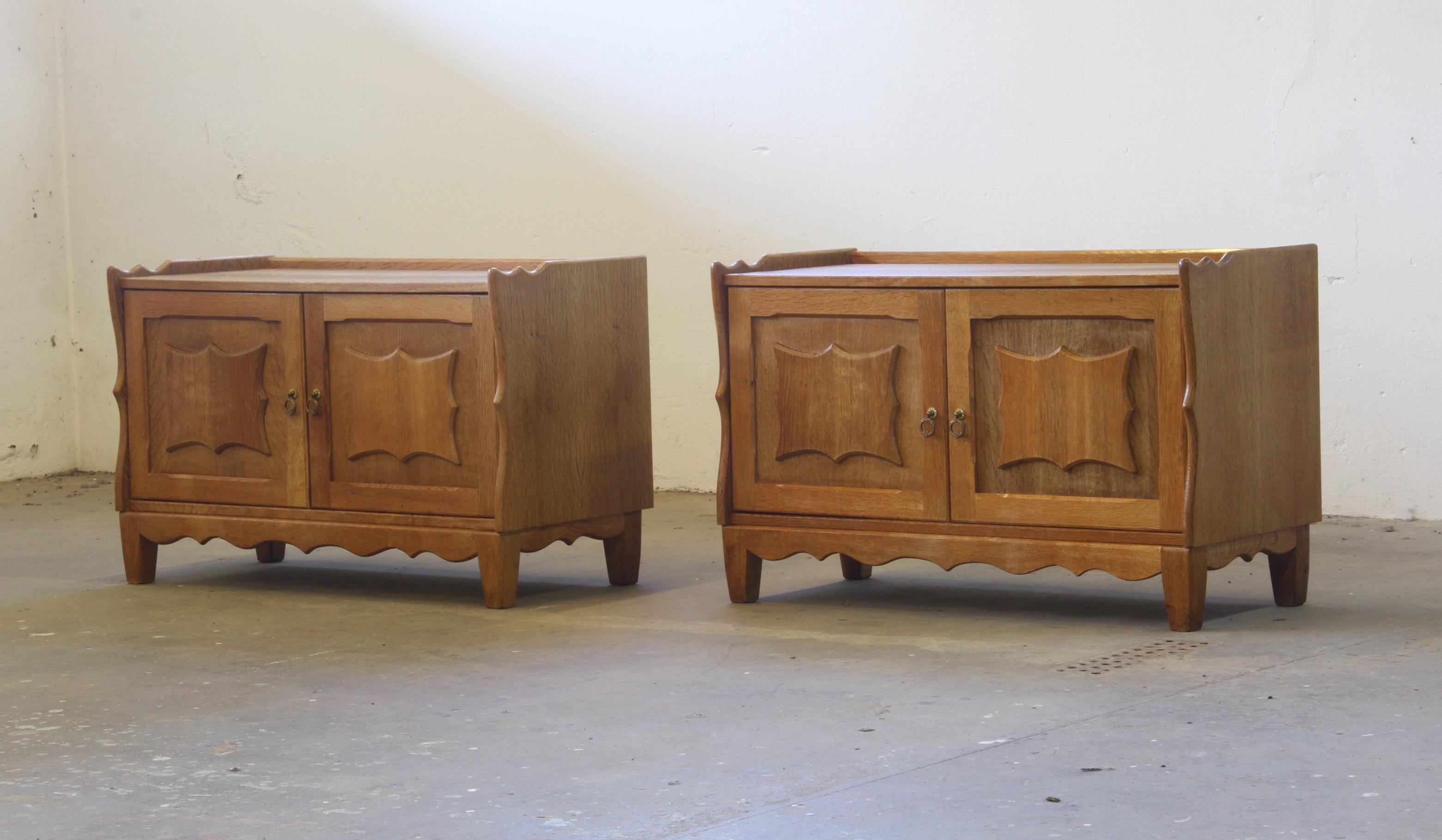 A Danish Mid-century Modern set of cabinets or compact sideboards made from Nordic oak. Manufactured in Denmark during the 1960/70s and often attributed to the renowned Danish designer Henning/Henry Kjærnulf. Kjærnulf is globally recognized for his