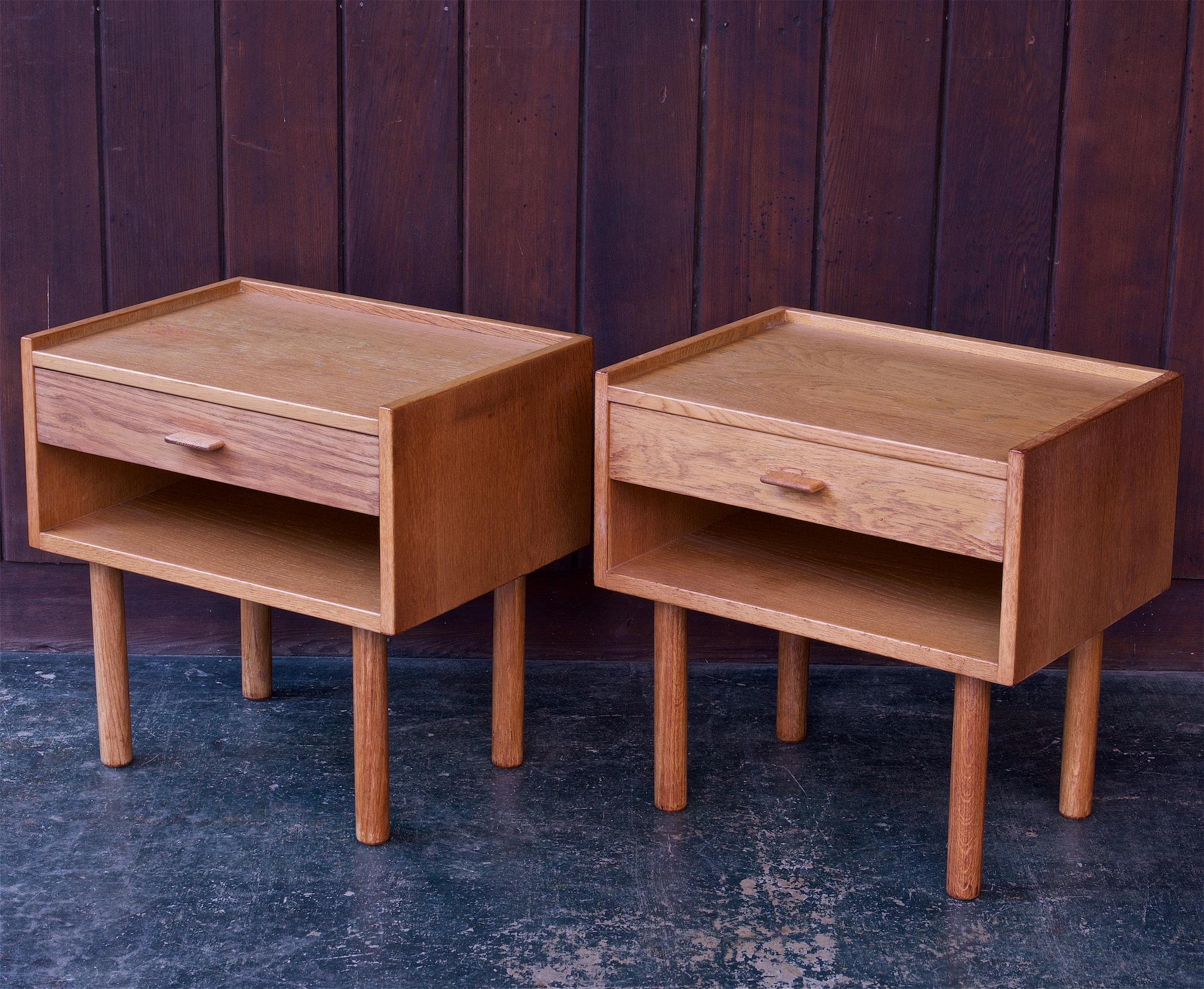 Pair of well worn and patinated oak nightstands, stamped on bottom, made in denmark.