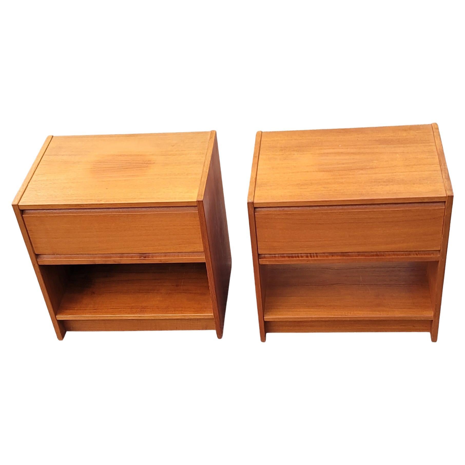 A pair of Vintage Danish Modern one drawer teak nightstands with dovetailed drawer joinery. 
Good vintage condition. Measure 13.75