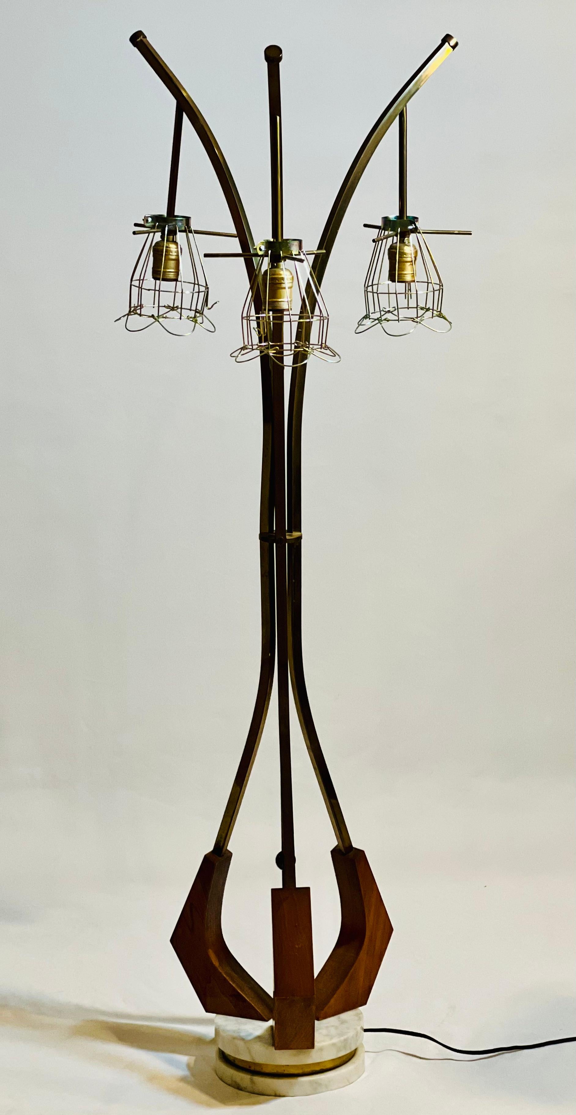 Vintage Danish modern three-light floor lamp, circa 1960's.

Unique sculptural organic form lamp crafted of brass and teak with a stacked marble and brass base. Shaped like a tree or plant, it features three hanging pendant lamps with open brass