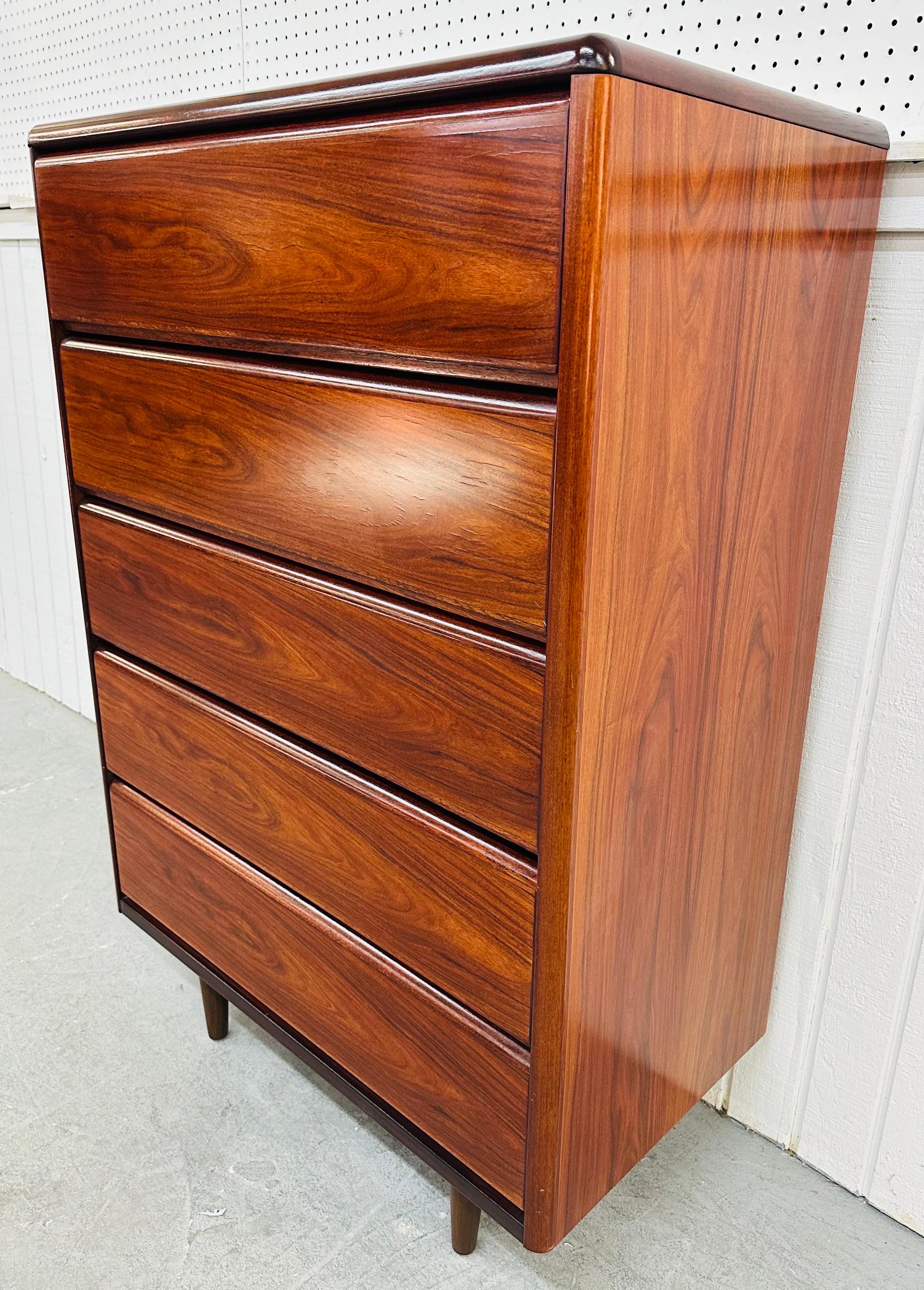 This listing is for a Vintage Danish Modern Rosewood High Chest. Featuring a straight line design, five drawers for storage, modern legs, and a beautiful rosewood finish. This is an exceptional combination of quality and design by Skovby!