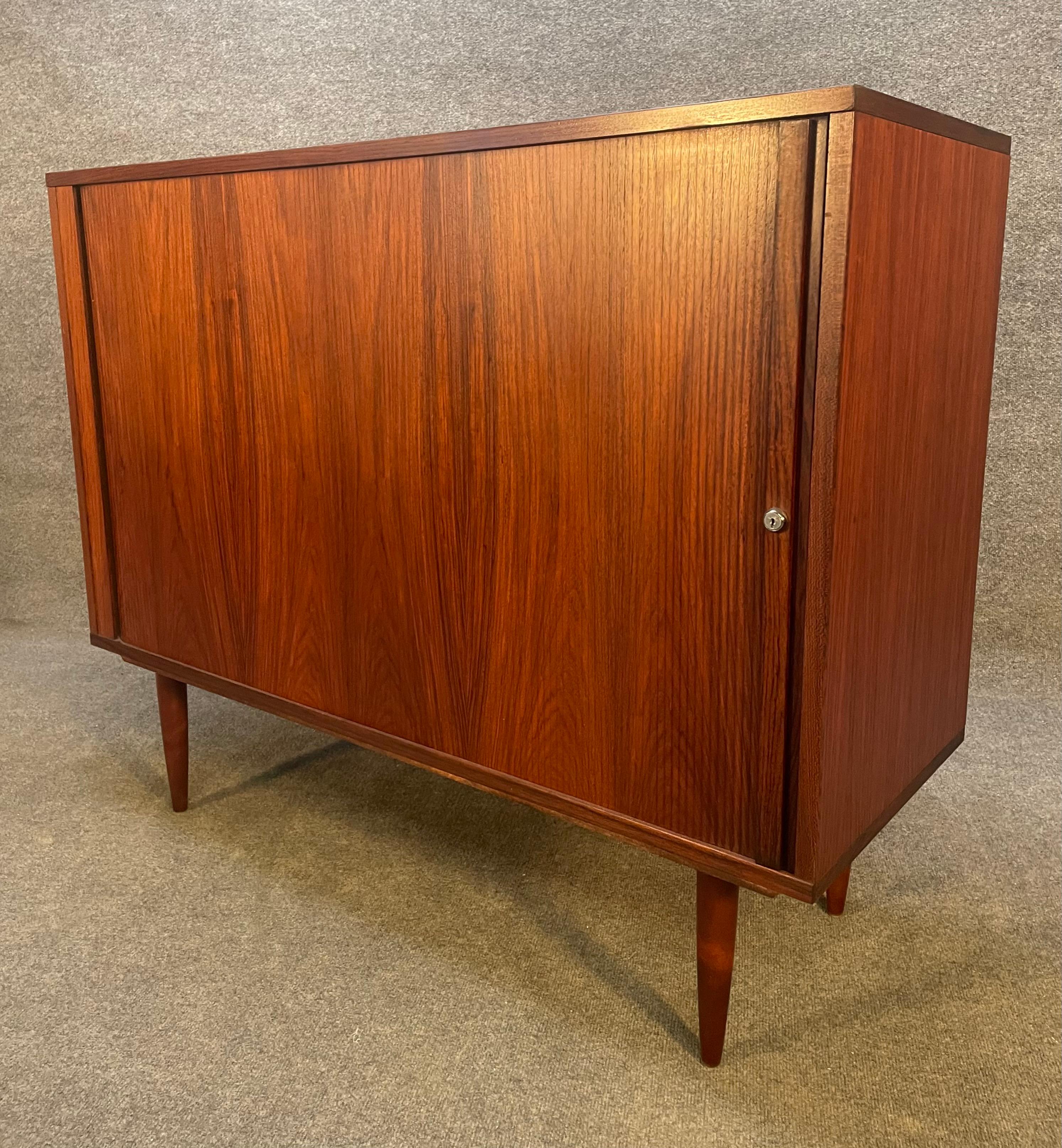 Here is a beautiful Scandinavian Modern cabinet in Brazilian rosewood designed by Marius Byrialsen and manufactured by Nipu Mobler in Denmark in the 1970s.
This exquisite case piece, recently imported from Europe to California before its