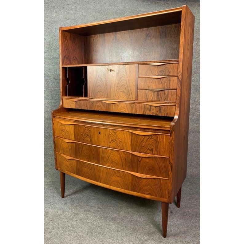 Here is a beautiful 1960s Scandinavian modern secretary desk in rosewood attributed to famed danish designer Erling Torvits that was recently imported from Copenhagen to California.
This piece features on its upper side a bookshelf, a cubby with