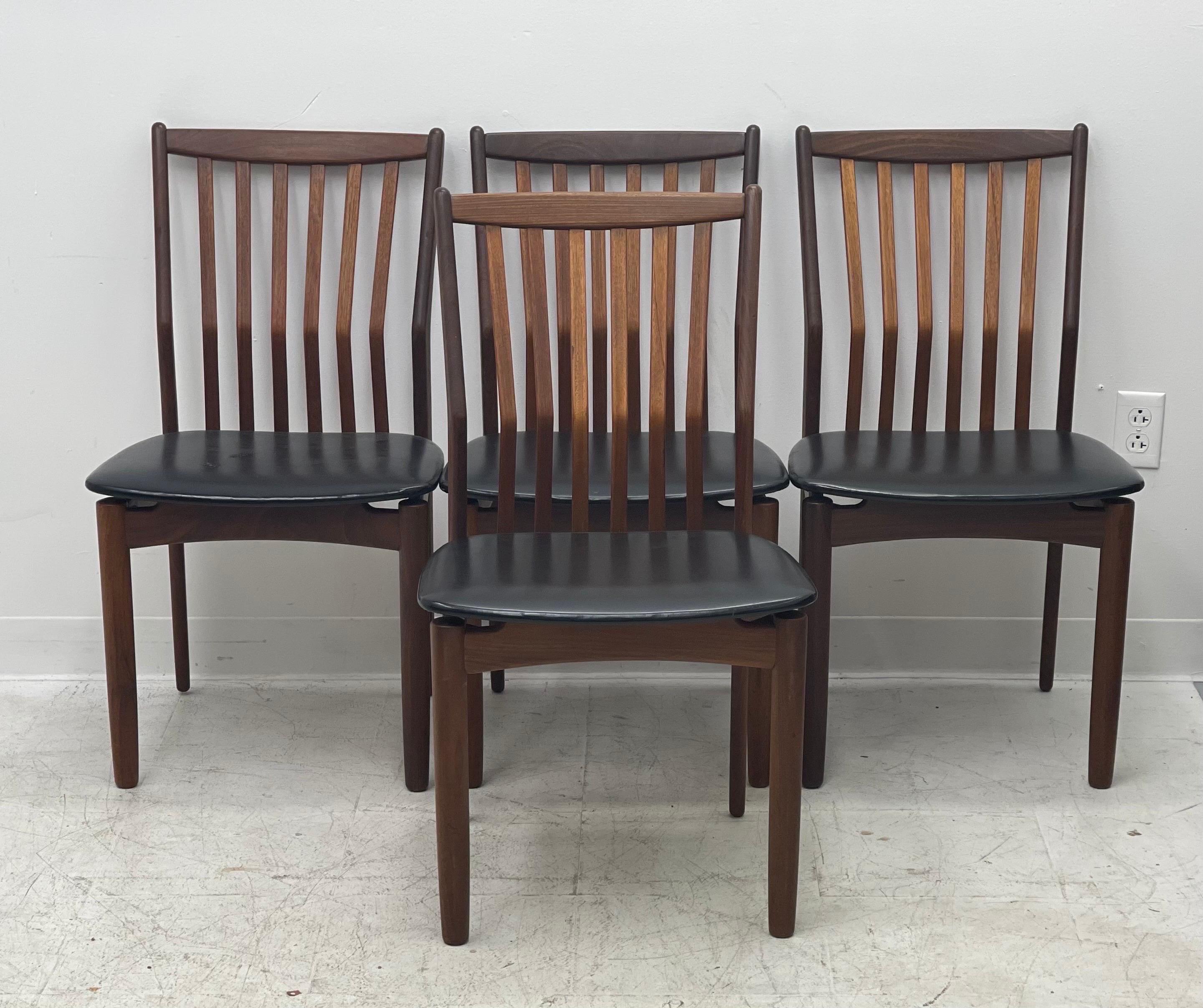 Mid-Century Modern set of four dining chairs in teak and afromasia, Denmark circa 1960’s. Features a supporting curved backrest and a wide frame seat unusual for Danish design. Retains the original black leatherette seats.

Dimensions: 19? W,