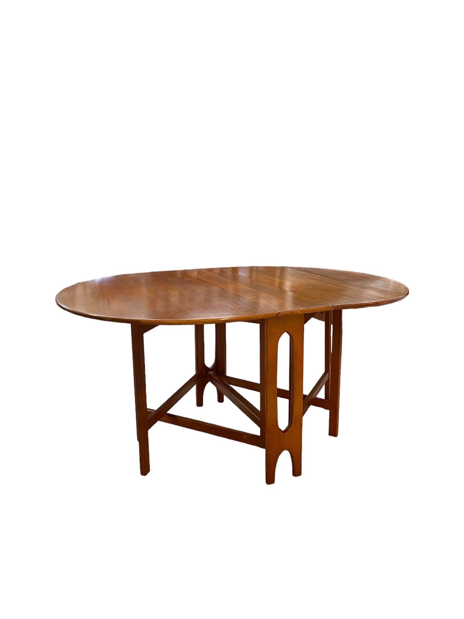 Vintage Folding Dining Table . Possibly Teak. Danish Modern Style. The Legs Interlock Under the Table for Stability. Vintage Condition Consistent with Age as Pictured.

Dimensions. 60 W ; 42 D ; 29 H