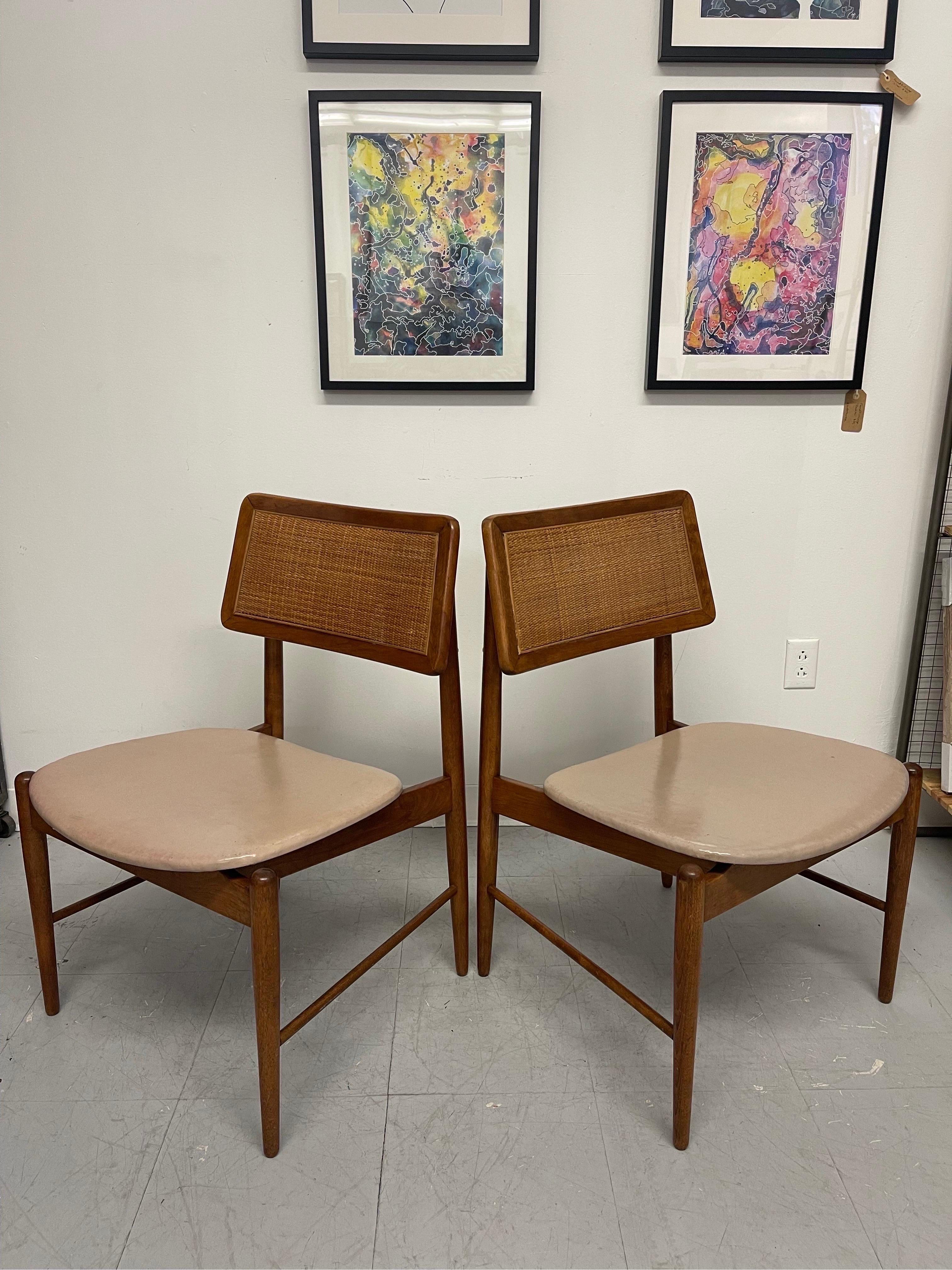 Vintage Chair Set with Walnut Toned Wood, Rattan Accent , and Beige Toned Seating. In the Style of Arne Vodder. MCM Lines Throughout. Circa 1960s - 1970s. Vintage Condition Consistent with Age as Pictured.

Dimensions. 22 W ; 20 D ; 32 H