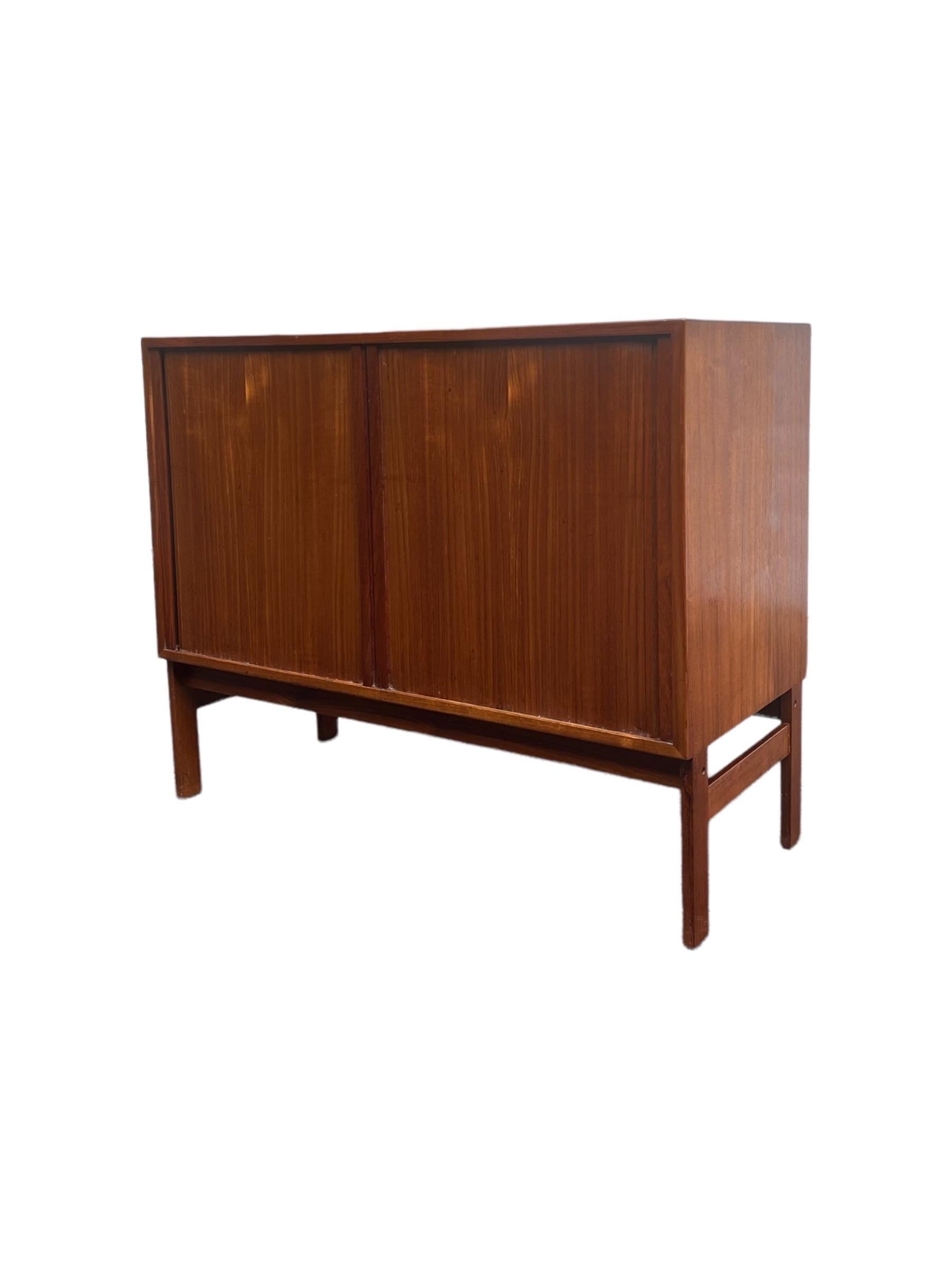 Vintage Danish Modern Tambour door Record cabinet of Credenza Imported. Shelf adjustable and or removable 

Dimensions: 35 W 16 D 29 H.
