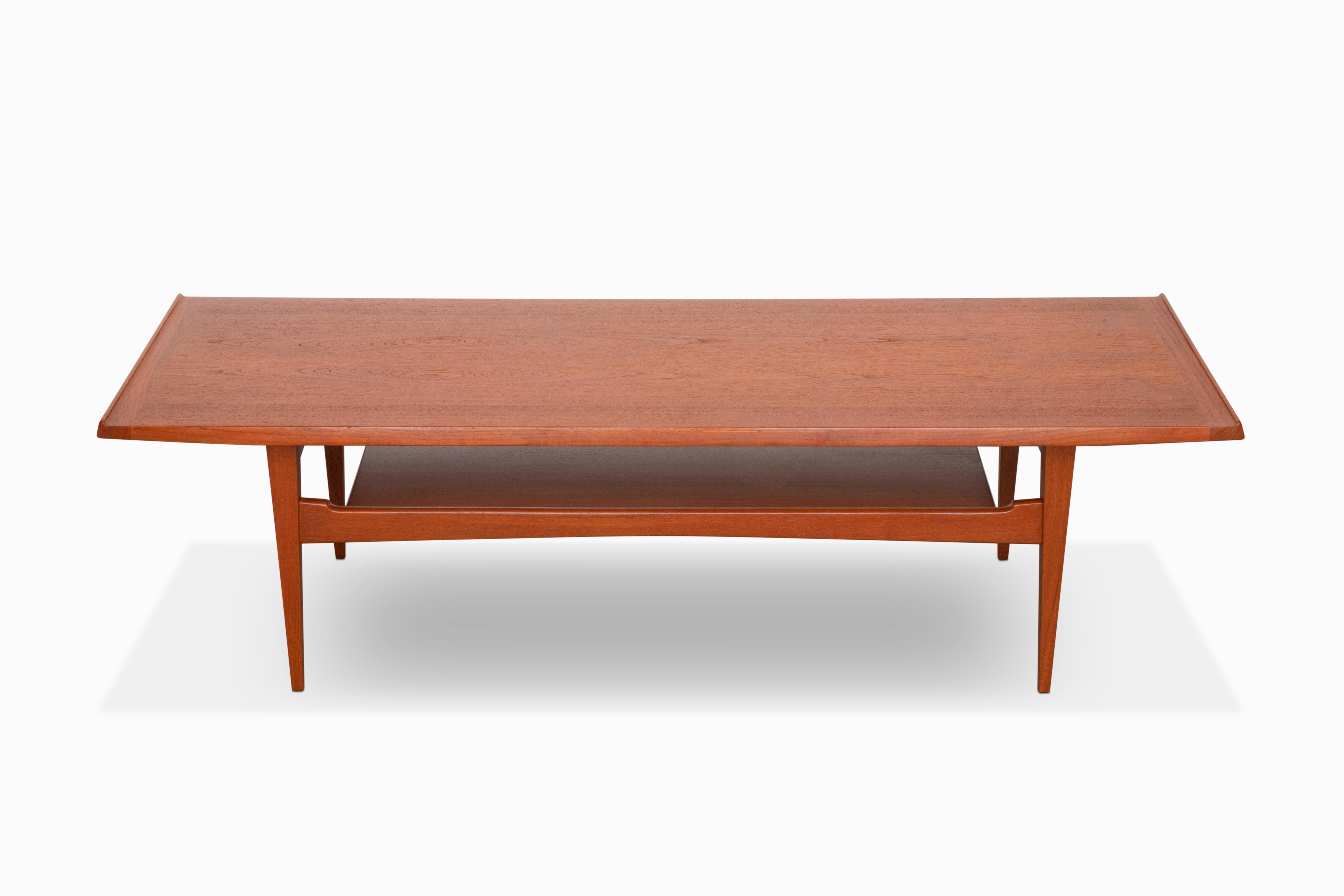 Here is a beautiful mid-century modern coffee table by Moreddi of Denmark. The teak construction features a lower shelf, sharply tapered legs and raised lips on the edges.  The sleek lines and angular design of this table are quite stunning.  It is