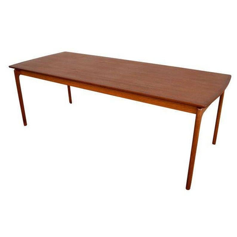 Here is a beautiful large rectangular coffee table designed by Ole Wanscher, circa 1960s manufactured by Poul Jeppesen in Denmark and recently imported to California.
It features a large floating tabletop with a glowing teak grain resting on four