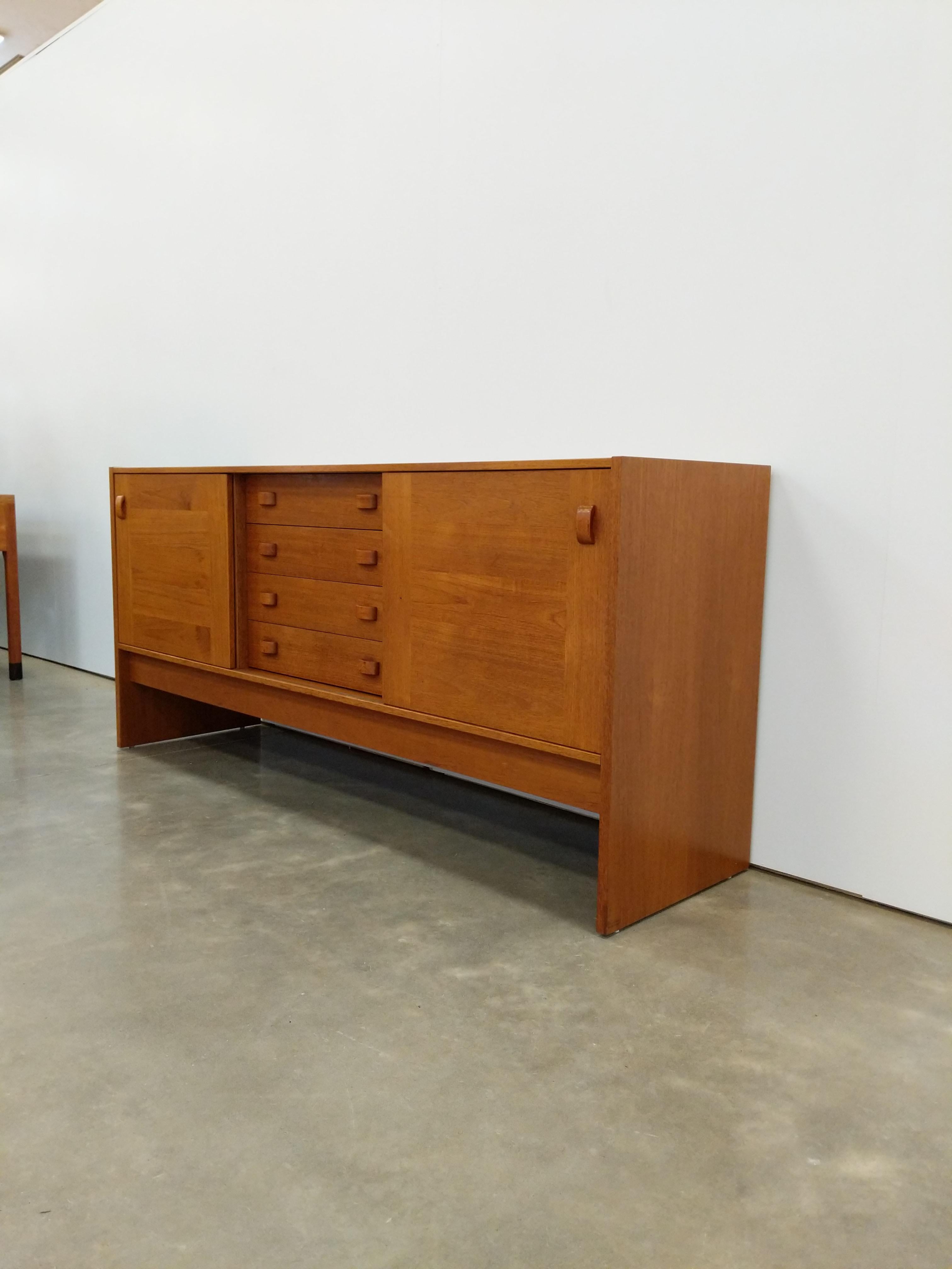 Authentic vintage Danish mid century modern teak credenza / sideboard / media console.

Maker's label on back.

This piece can accommodate 12 inch vinyl records.

Interior shelves are removable and height-adjustable.

This piece is in excellent