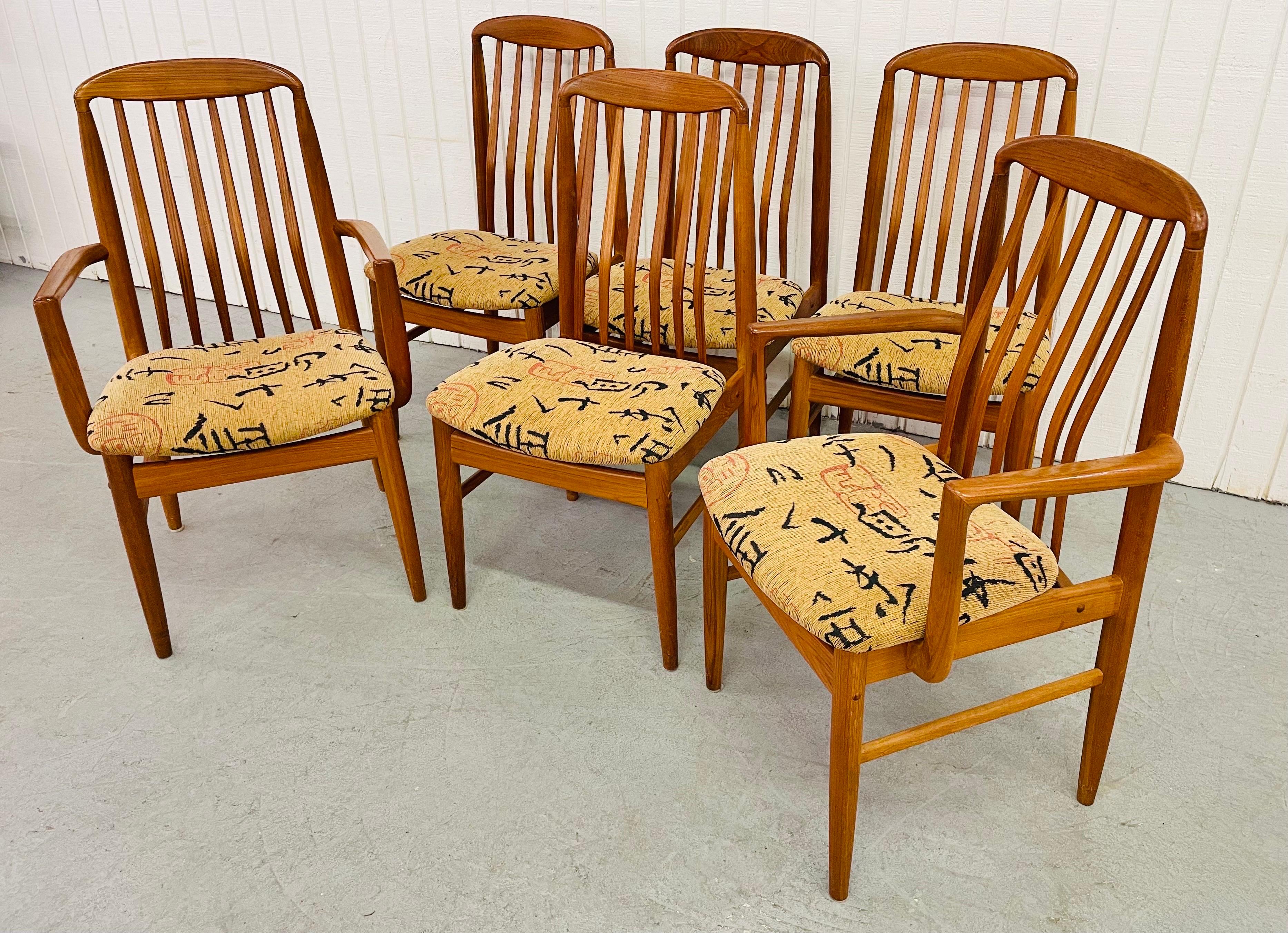 This listing is for a set of six vintage Danish Modern Teak Dining Chairs. Featuring two arm chairs, four straight chairs, original upholstery, and a beautiful teak finish.
