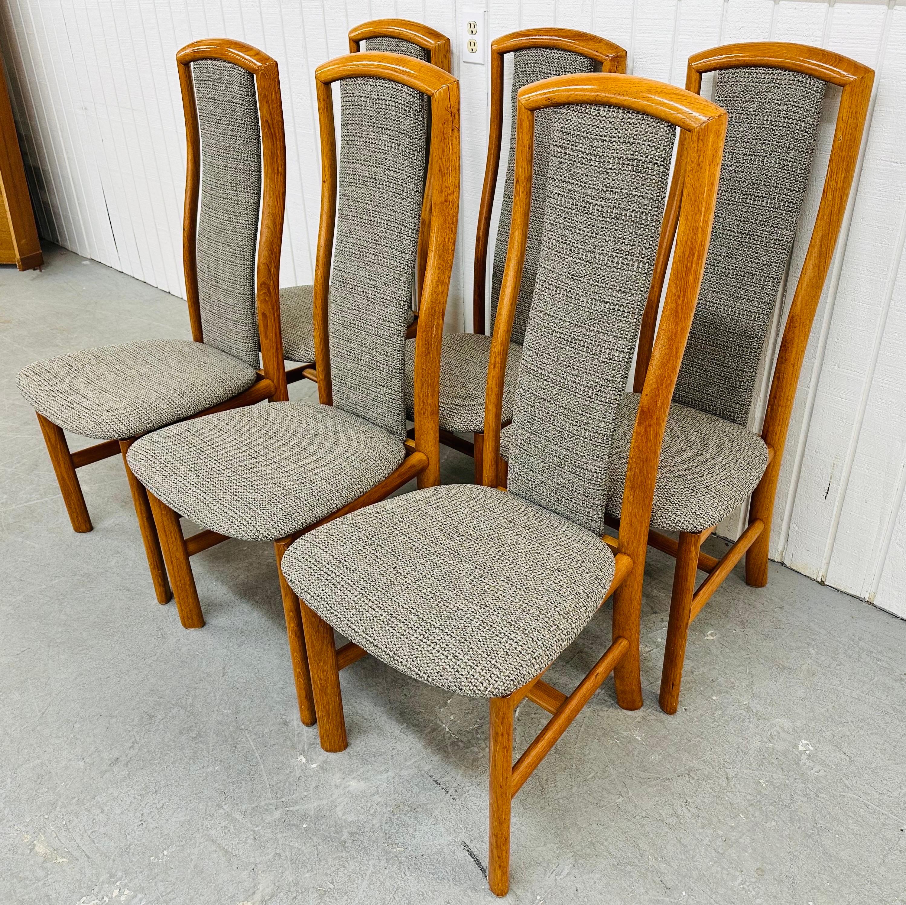 This listing is for a set of Vintage Danish Modern Teak Dining Chairs. Featuring a high back design, solid wood teak frames, and new gray upholstery. This is an exceptional combination of quality and design by Skovby!