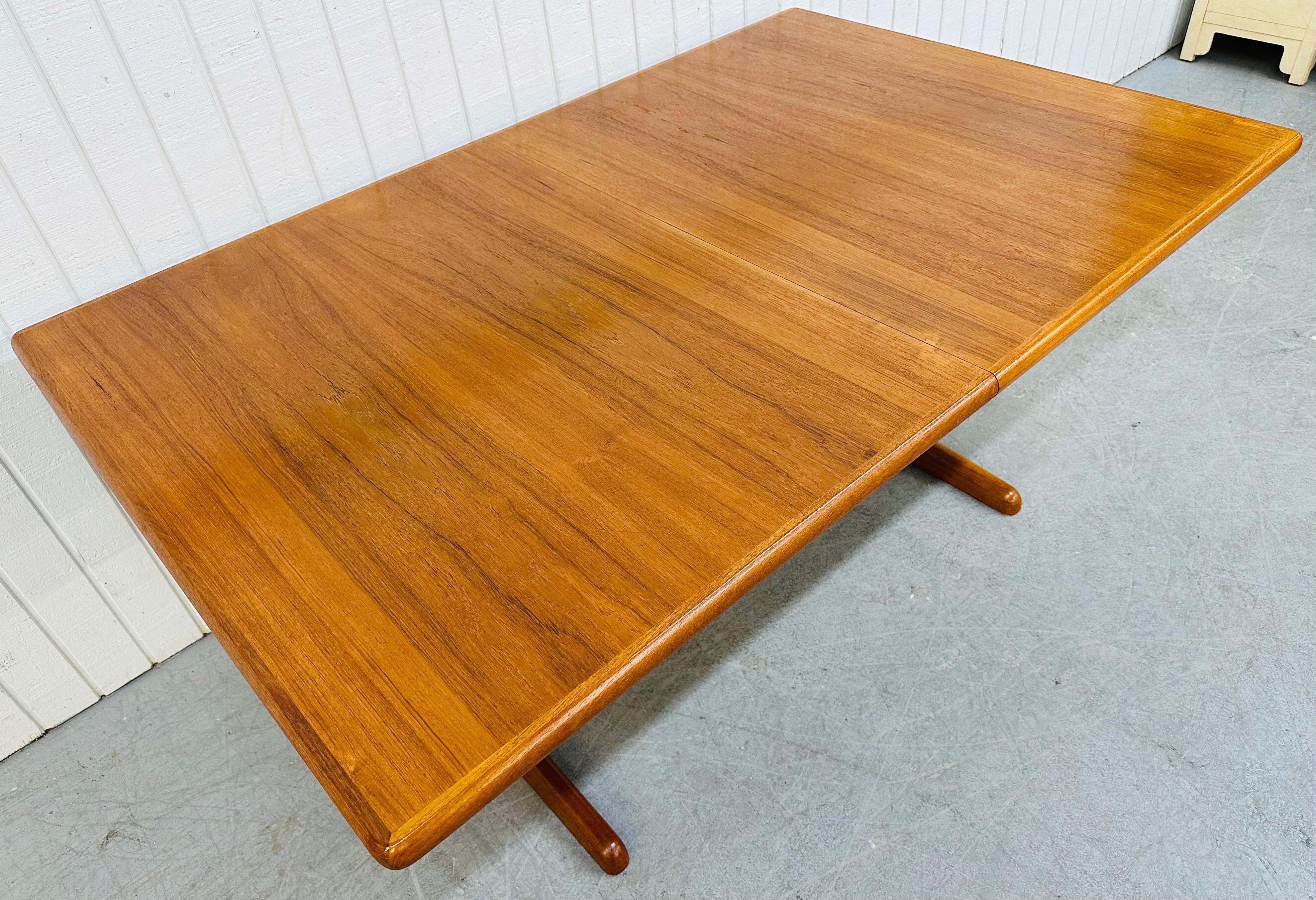 This listing is for a Vintage Danish Modern Teak Dining Table. Featuring a rectangular top, straight line pedestal base, hidden pop-up leaves that extend the table up to 96” L, and a beautiful teak finish.