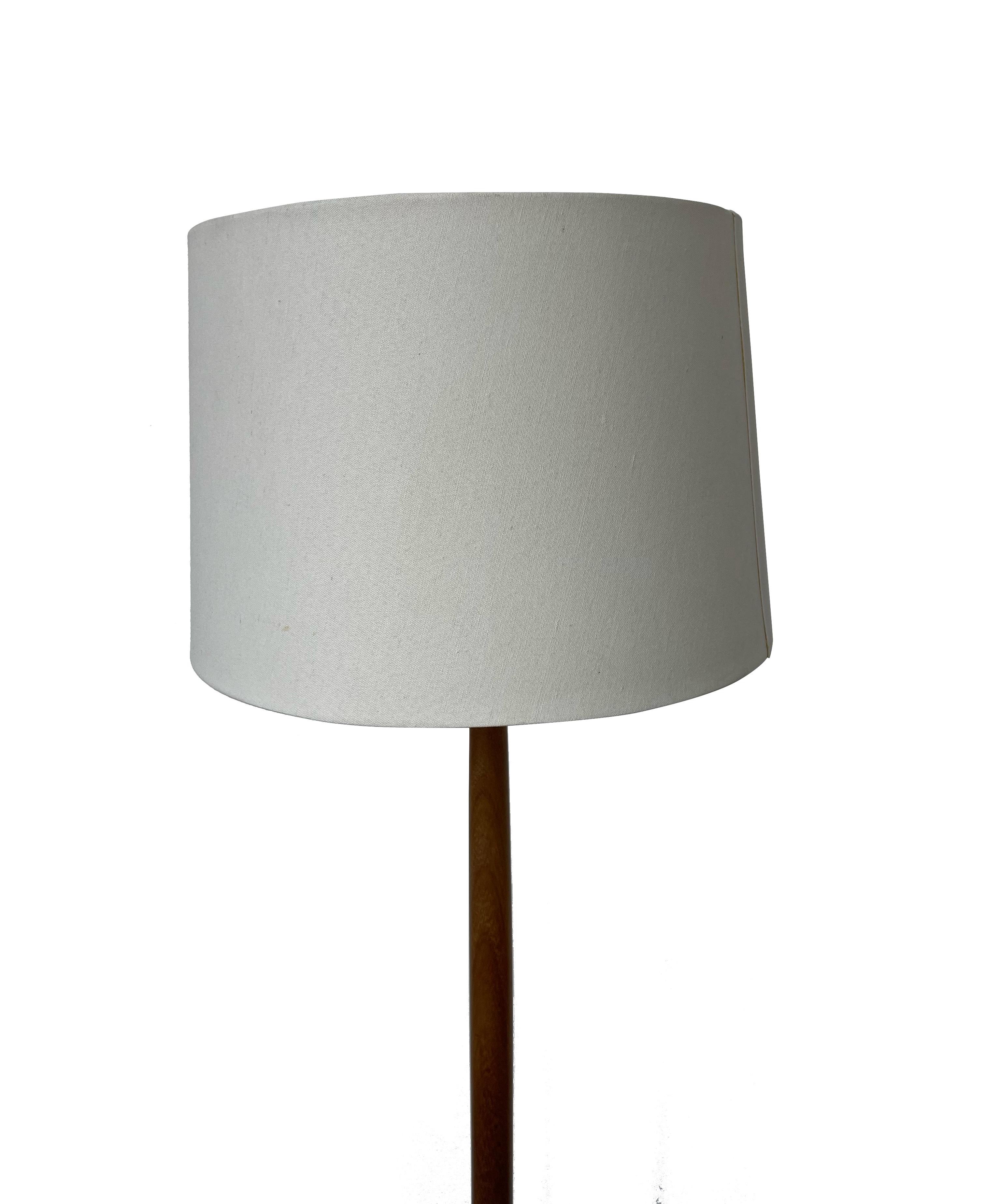 A stunning Vintage Danish Mid-Century Modern Onion Teak Floor Lamp by Basic Concept Lightolier. Crafted with teak wood, this floor lamp exudes a timeless charm that seamlessly blends with various interior styles.