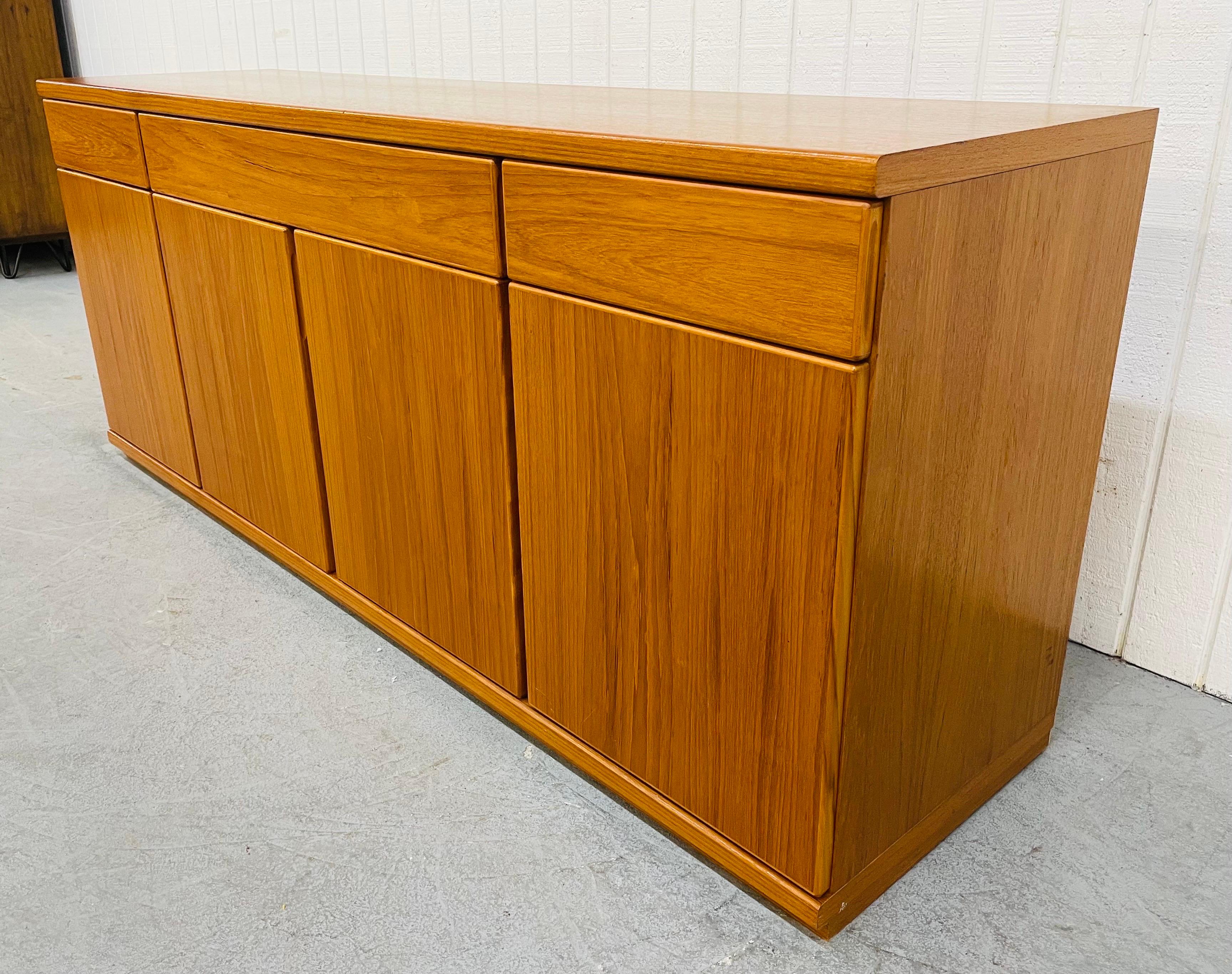This listing is for a vintage Danish Modern teak sideboard. Featuring a beautiful rectangular teak top, three drawers for storage, two doors on each end that open up to a shelf, and two doors that open up in the center to a shelf.