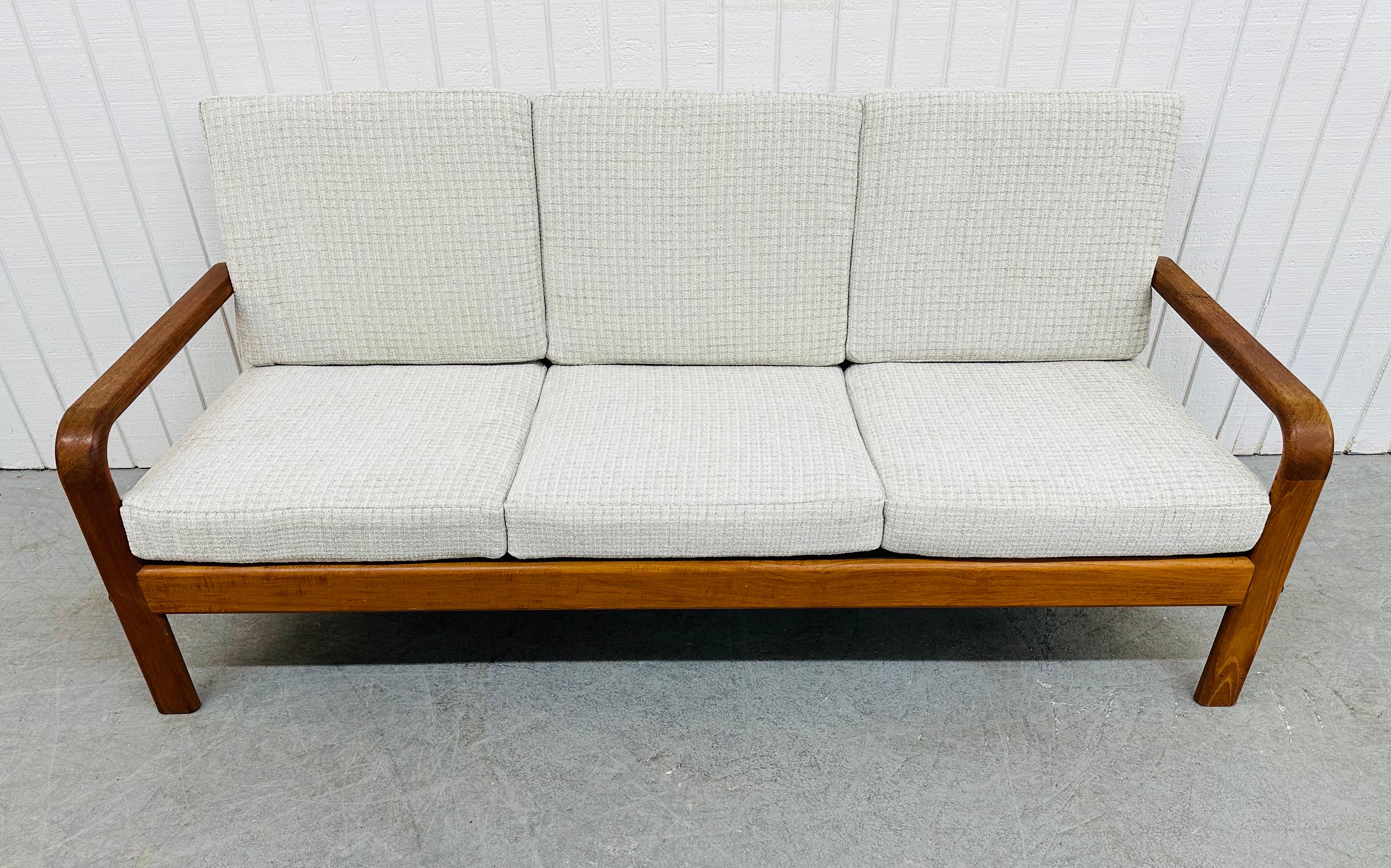 This listing is for a Vintage Danish Modern Teak Sofa. Featuring a teak frame, newly upholstered cushions, and seating space for up to three people. This is an exceptional combination of quality and design!