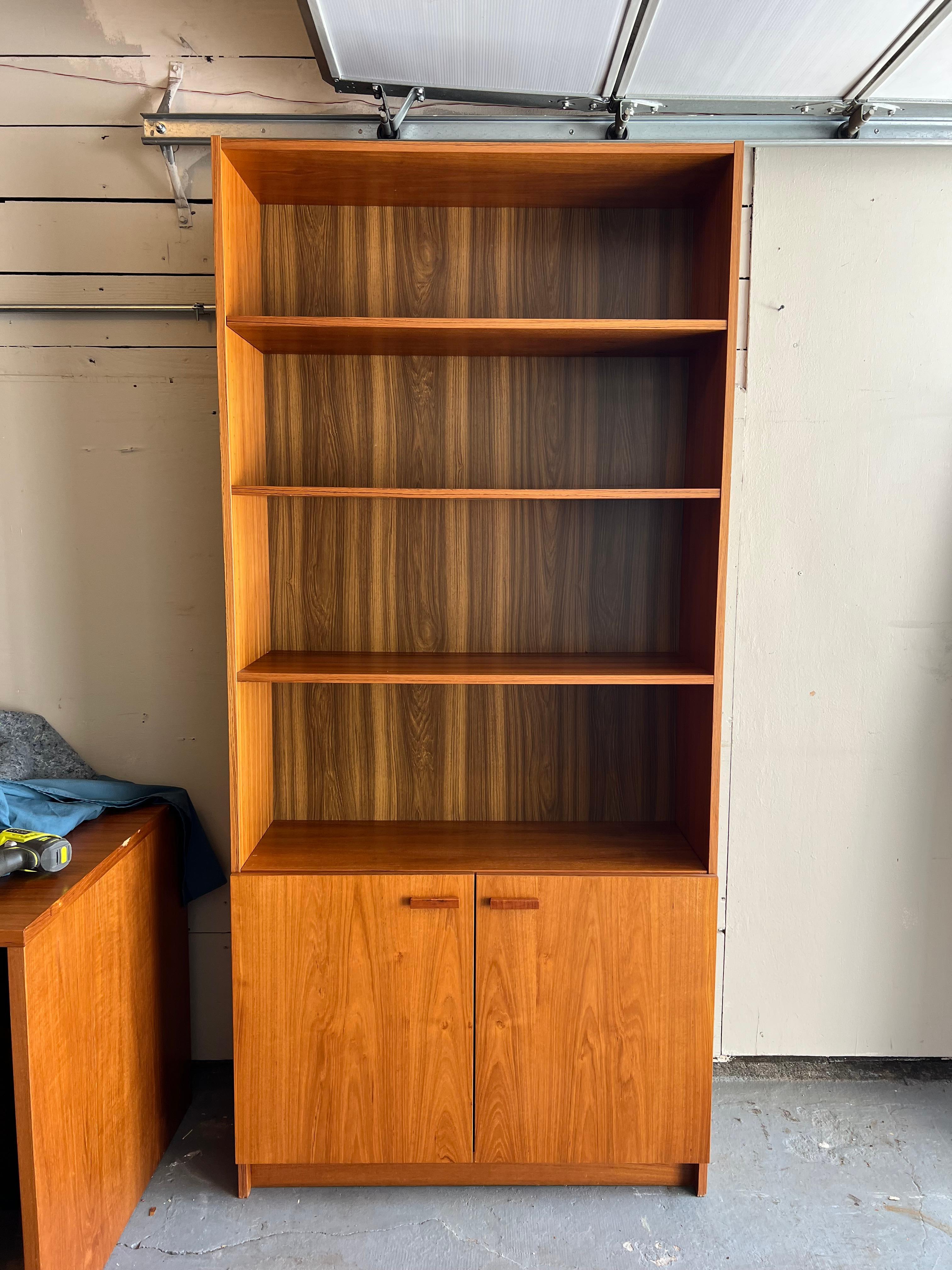 The best clean cut storage solution. Rare depth compared to similar units. Makes this piece all the more versatile. Two adjustable shelves, and cabinet doors can be adjusted as well. ie the enclosed portion of the unit could be in the center, or at
