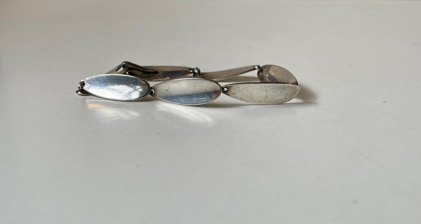 A. modernist sterling silver bracelet designed by silversmith Arne Johansen and studio-made circa 1960-70. Hallmarked: Sterling, AJ, Denmark. Reminiscent in style to similar period designs from Georg Jensen, Hans Hansen and David Andersen.