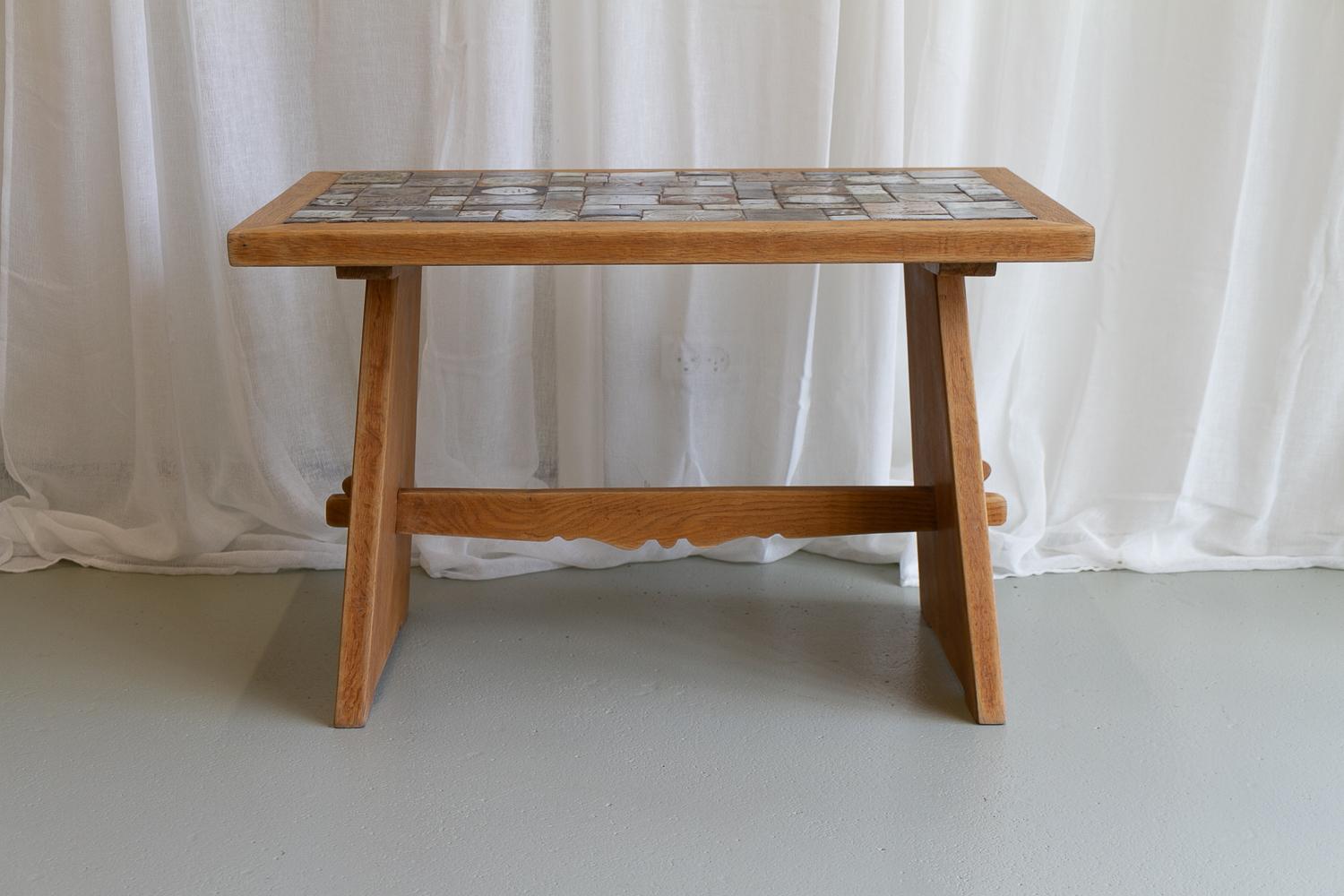 Vintage Danish Oak Coffee Table Attributed to Tue Poulsen, 1960s.
Danish Mid-Century Modern coffee or side table in brutalist style. Frame in Nordic oak. Ceramic tiles are individually hand made in different sizes, patterns and colors.
The tiles are