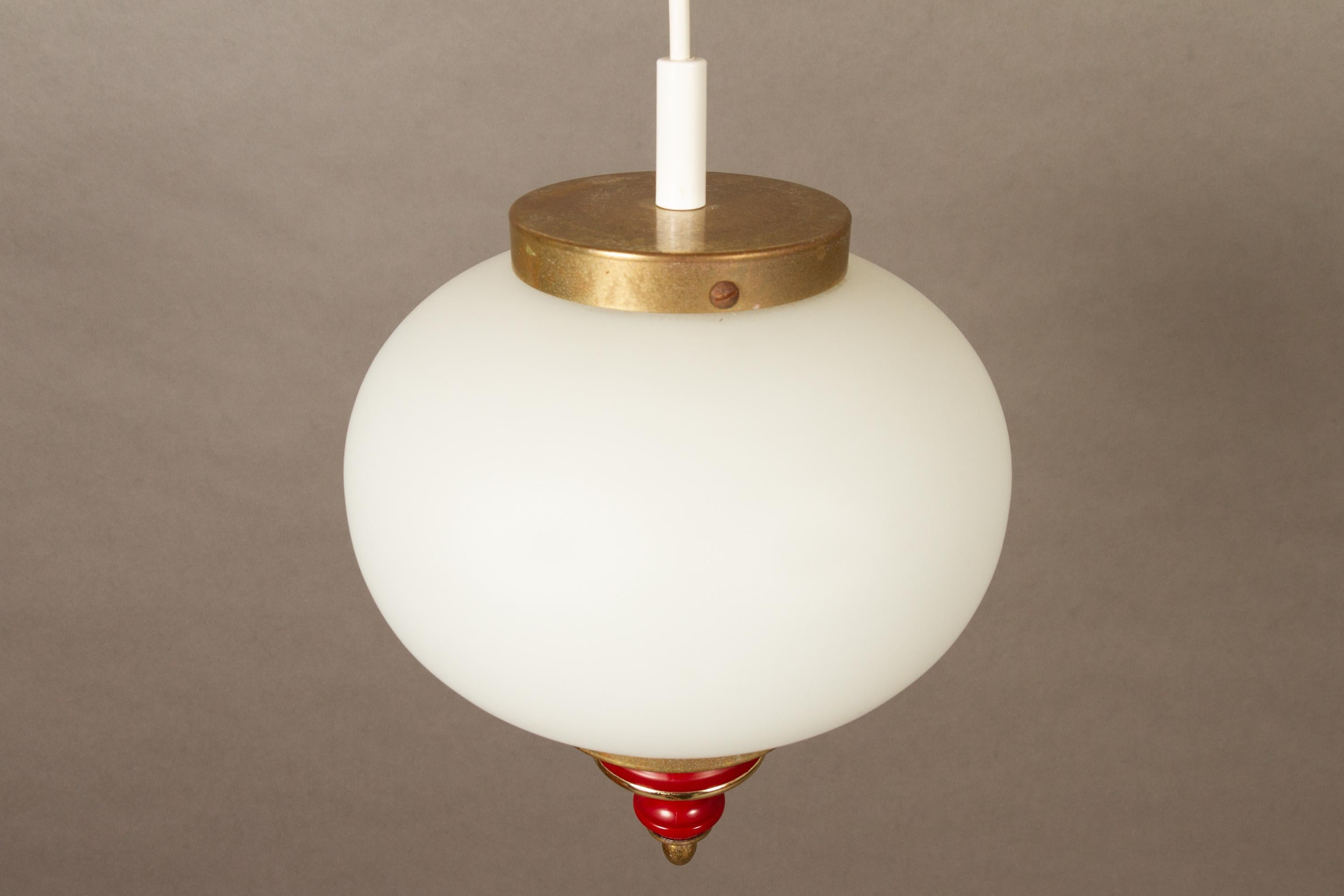 Vintage Danish opal ceiling lamp, 1950s.
Round opal-white glass with brass top and decorative brass and red lacquer spinke in the bottom. Emits a soft light.
Good vintage condition. Glass has no cracks.