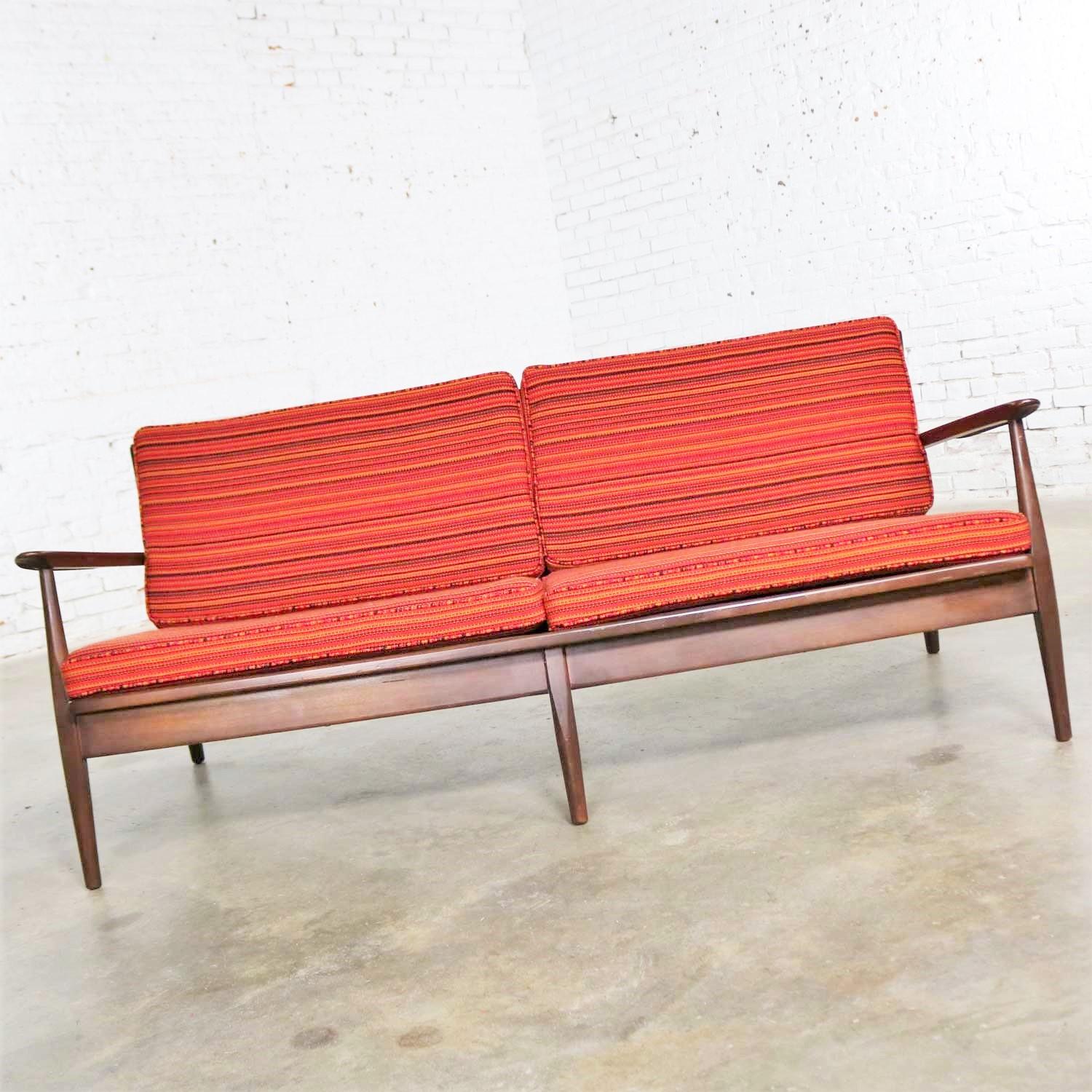 Handsome vintage Danish modern or Scandinavian Modern loose cushion sofa with new but vintage old stock red, golden, and dark brown horizontal striped fabric. This sofa is in overall fabulous condition. The wood frame is in original vintage