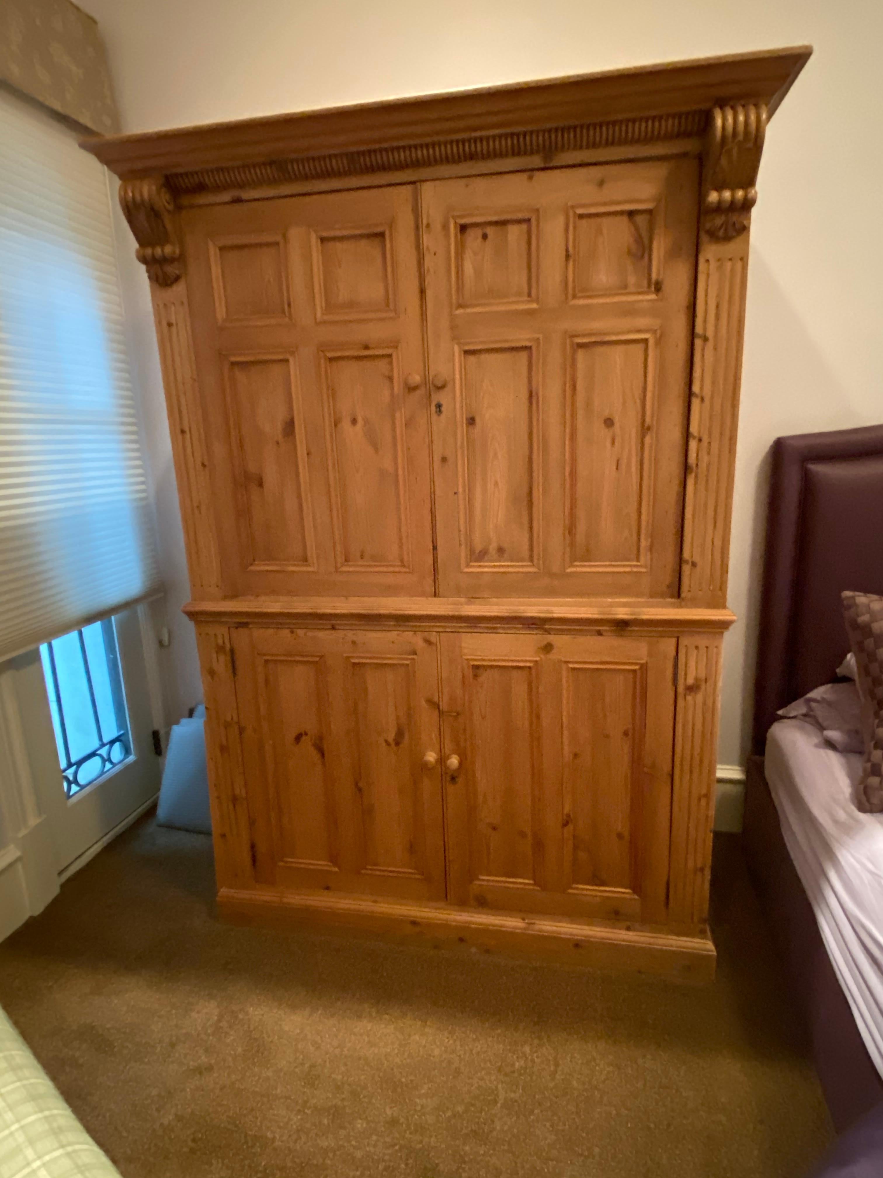 This lovely honey-colored pine armoire from Europe circa 1880, has two doors with recessed panels that are on retractable glides (pocket doors), Comes with working lock & key, with original nickel plates & turned wooden pulls. Provides great storage