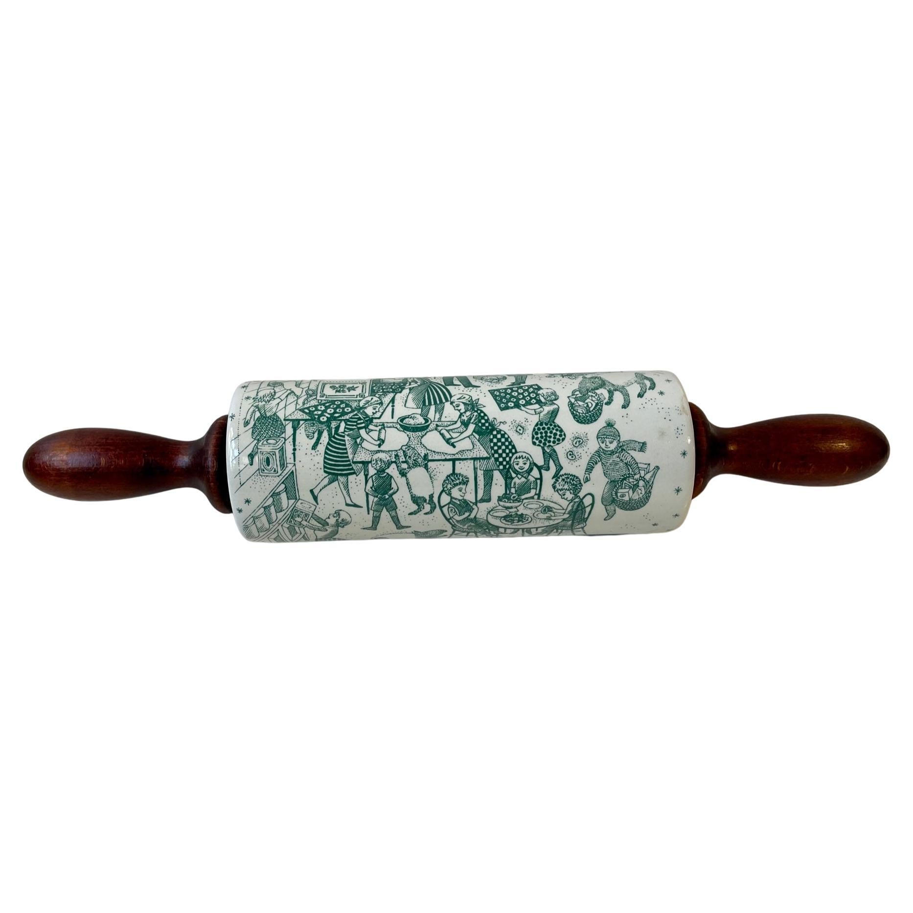 A very rare rolling pin fashioned from glazed porcelain and patinated oak. Its green motif is a micro-cosmos of a kitchen kaos. Very humorous, peculiar and funny especially given its age. It was designed by the Danish artist Paul Høyrup Jørgensen