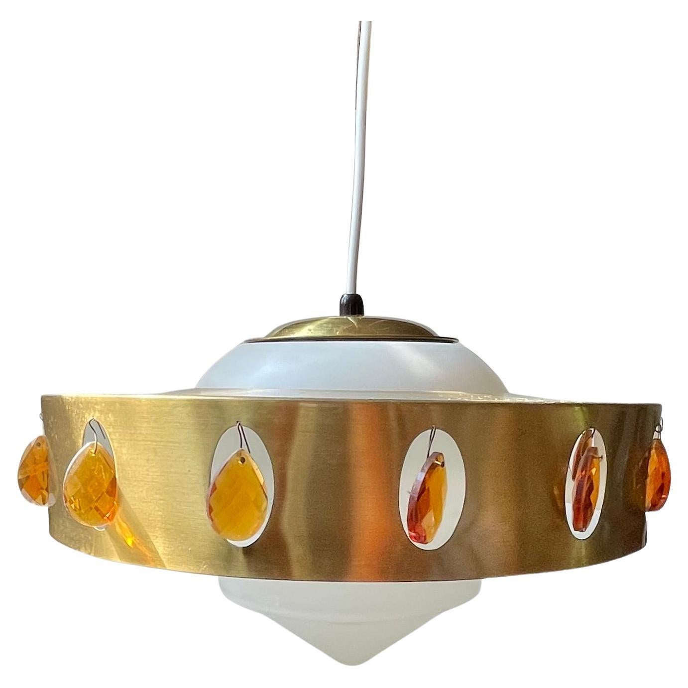 Unusual swag style pendant chandelier consisting of a 'spinner shaped' opaline glass shade topped with a solid brass shade decorated with orange prisms. Possibly made by Vitrika in Denmark circa 1970. Measurements: H: 25 cm, Diameter: 36 cm.