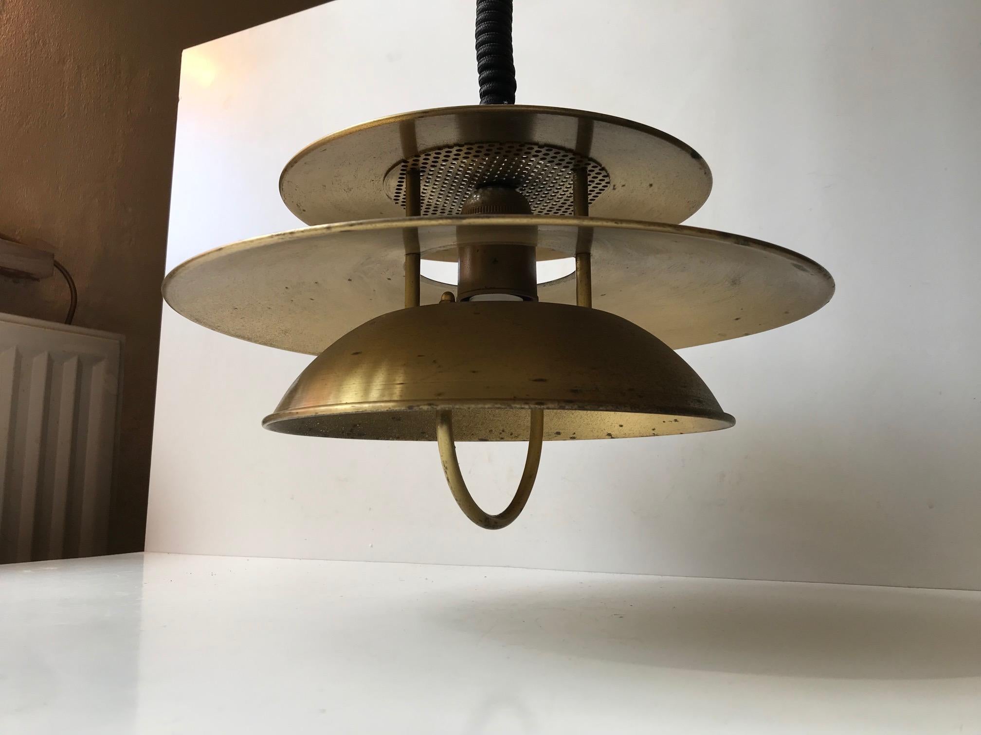 Tiered/multi-shaded hanging light with suspensions system - rise and fall. Hereby the height is easily adjusted by hand. Designed and manufactured by Vitrika in Denmark during the early 1970s. It has a Maritim/Nautical appearance. The construction