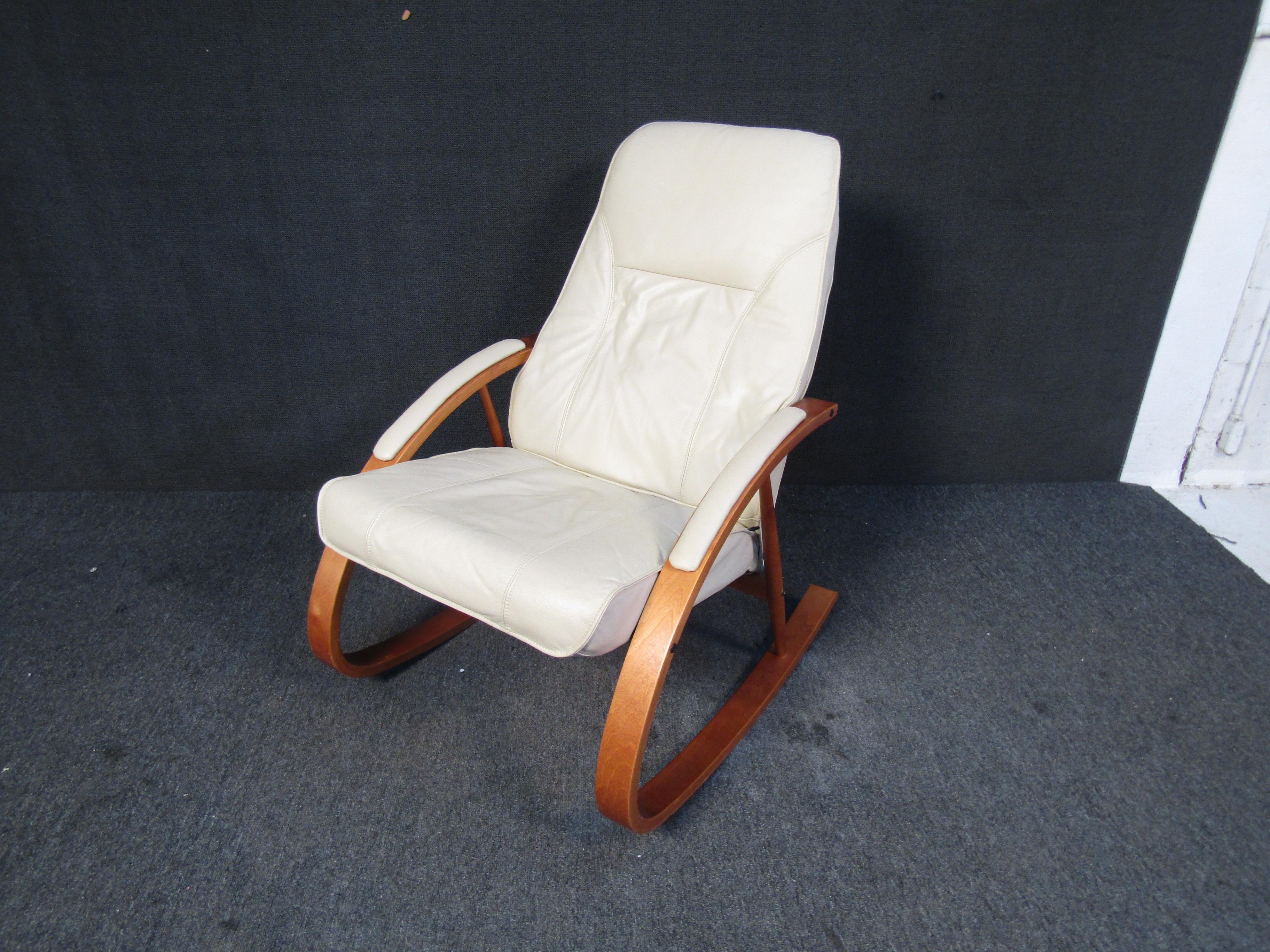 Combining an elegant curving teak frame with white leather, this vintage Danish rocker by Unico is as beautiful as it is comfortable. Please confirm item location with seller (NY/NJ).