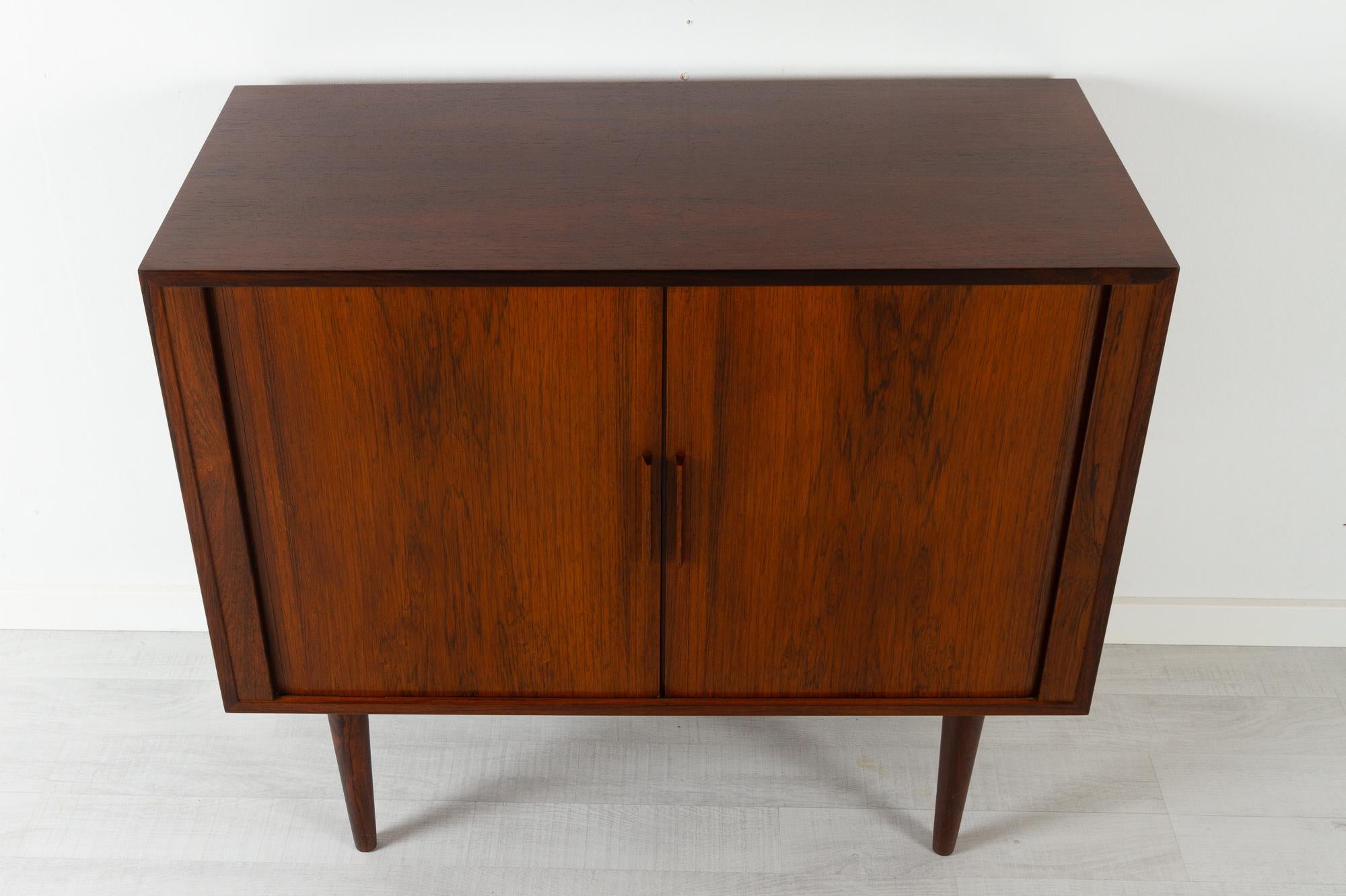 Vintage Danish rosewood cabinet with tambour doors by Kai Kristiansen 1960s
Danish Mid-Century Modern cabinet in rosewood designed by Danish architect Kai Kristiansen for Feldballes Møbelfabrik, Denmark.

This cabinet is part of the FM Reolen