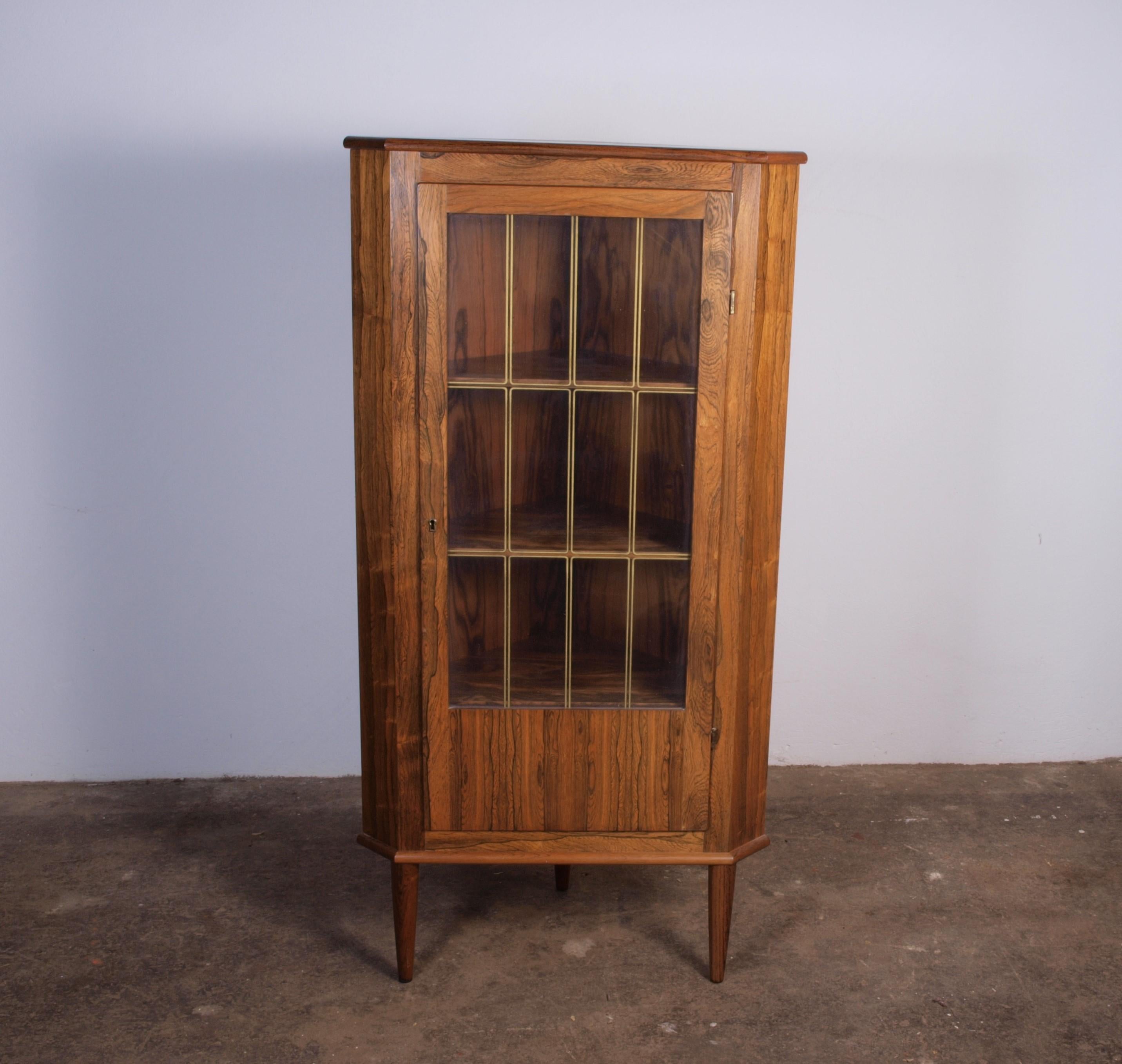 Vintage Danish rosewood corner cabinet from the 1960s, featuring a single large door, a rare find. This sleek piece has a clean design without drawers, showcasing simple yet stylish Danish Design. It serves as a Scandinavian Mid-Century Modern