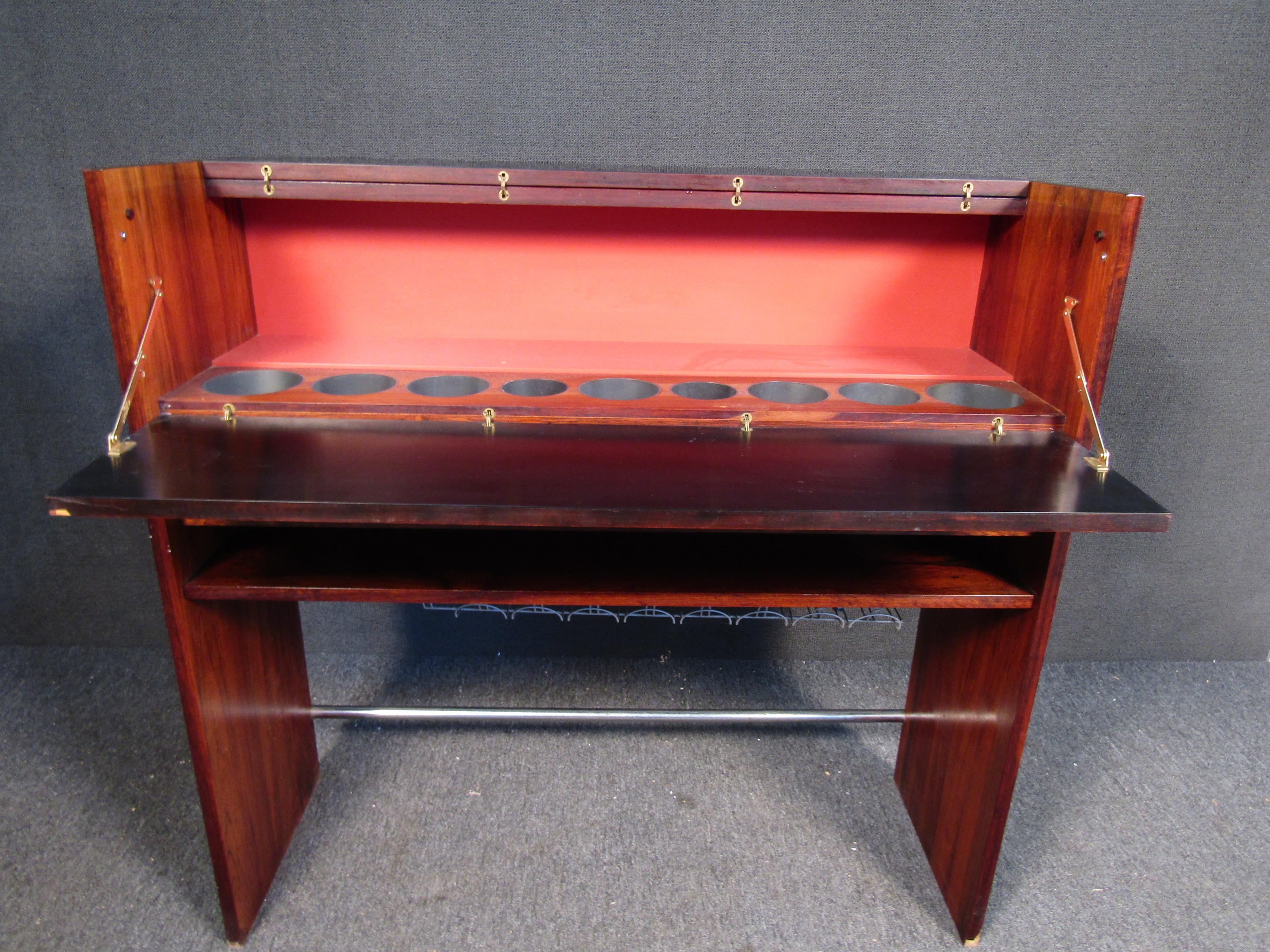 This vintage dry bar is built with vibrant rosewood and Mid-Century craftsmanship. Please confirm item location with seller (NY/NJ).