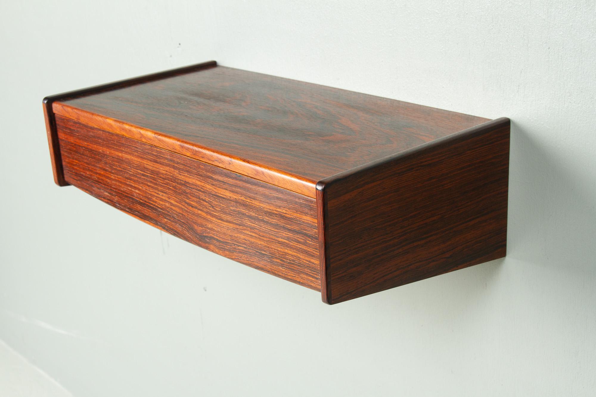 Vintage Danish Rosewood Floating Shelf, 1960s.
Mid-century modern wall mounted bedside table/nightstand/wall console made in Denmark in the 1960s. Featuring a single drawer with a smooth front. Sleek and minimalistic design.
Beautiful and