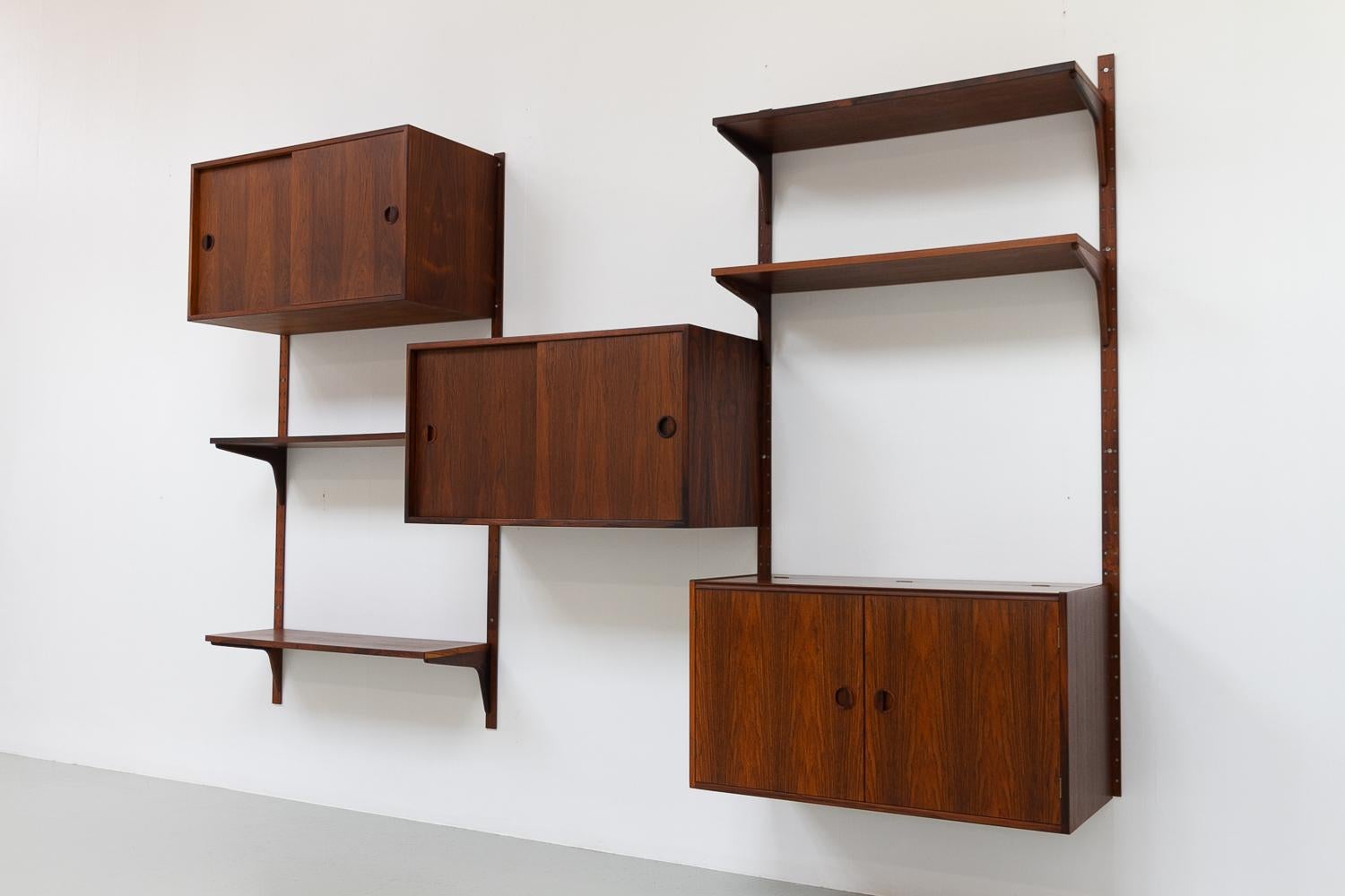 Vintage Danish Rosewood Modular Wall Unit by HG Furniture, 1960s.

Scandinavian modern 3-bay floating shelving system by Danish architects Rud Thygesen og Johnny Sørensen manufactured by HG Furniture (Hansen & Guldborg) Denmark.
This system is