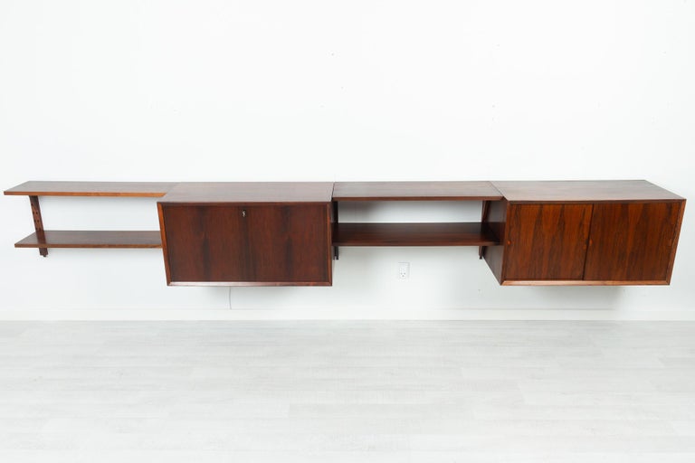 Vintage Danish rosewood modular wall unit by Poul Cadovius for Cado 1960s

Mid-Century Modern 4 bay shelving system model Cado. This is a original vintage floating bookcase designed by Danish architect Poul Cadovius. 
Here the elements are