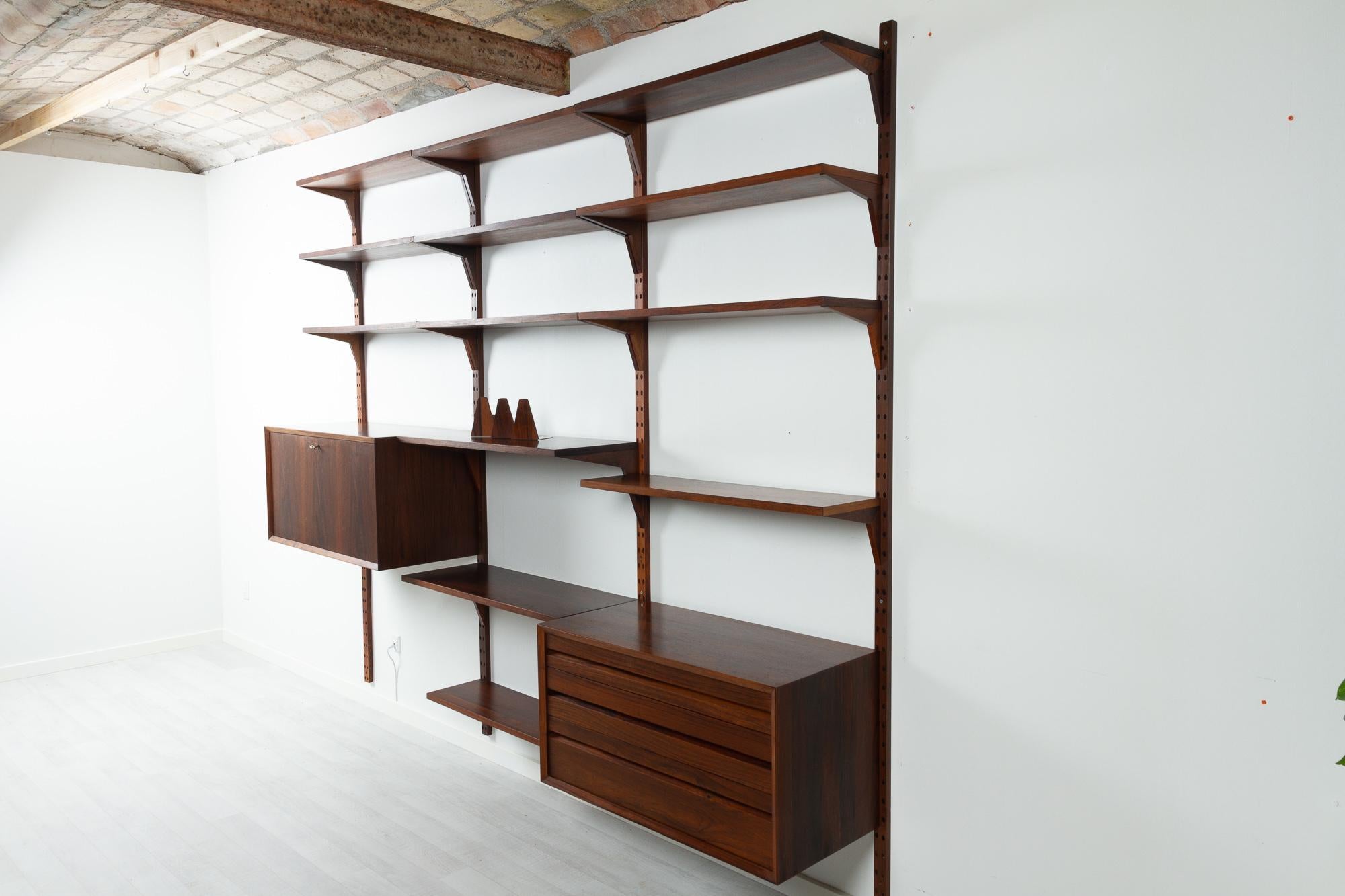 Vintage Danish rosewood modular wall unit by Poul Cadovius for Cado 1960s

Mid-Century Modern 3 bay shelving system model Cado. This is a original vintage floating bookcase designed by Danish architect Poul Cadovius. 
Cadovius had the