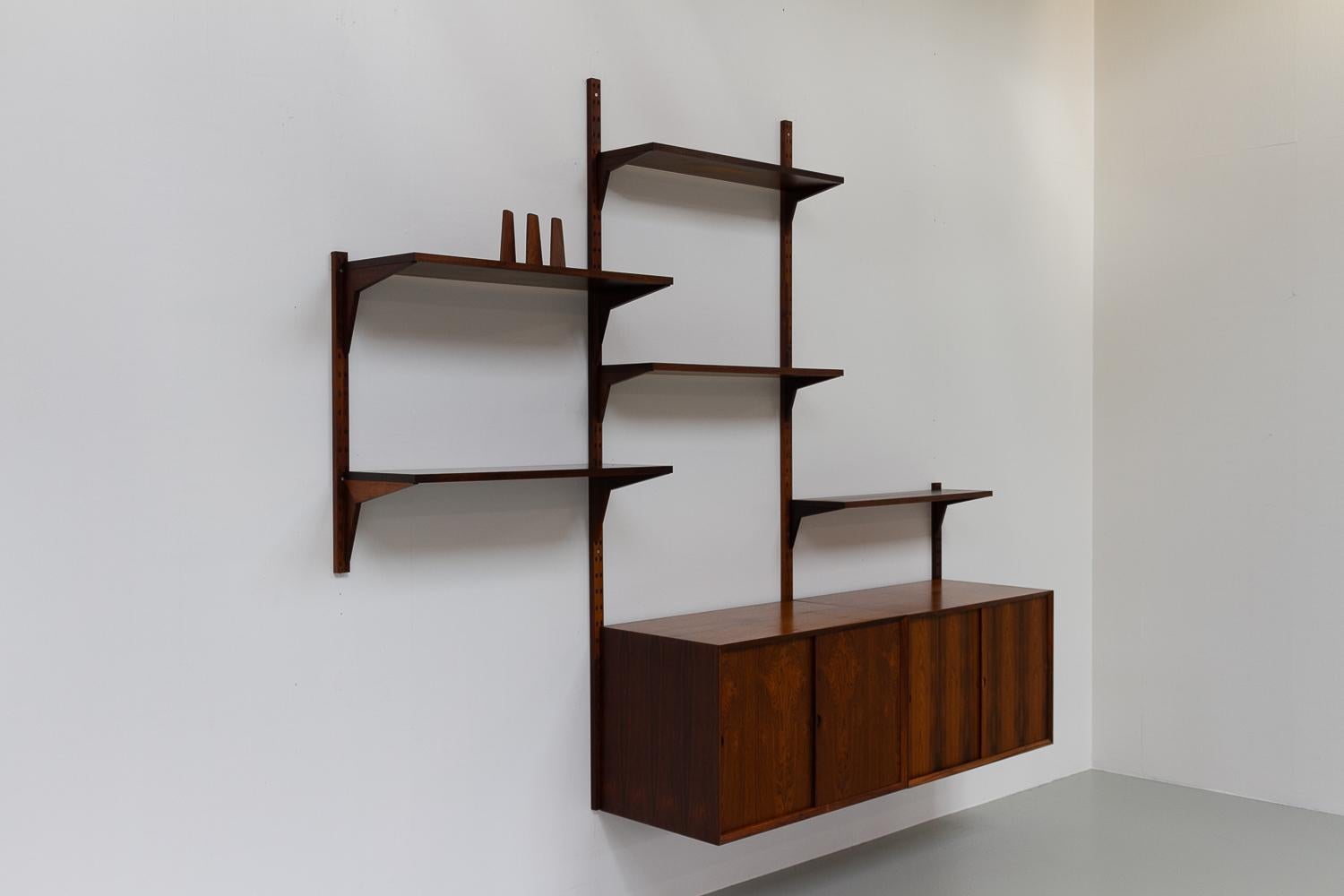 Vintage Danish rosewood modular wall unit by Poul Cadovius for Cado 1960s

Mid-Century Modern 3 bay shelving system model Cado. This is a original vintage floating bookcase designed by Danish architect Poul Cadovius. 
Cadovius had the revolutionary