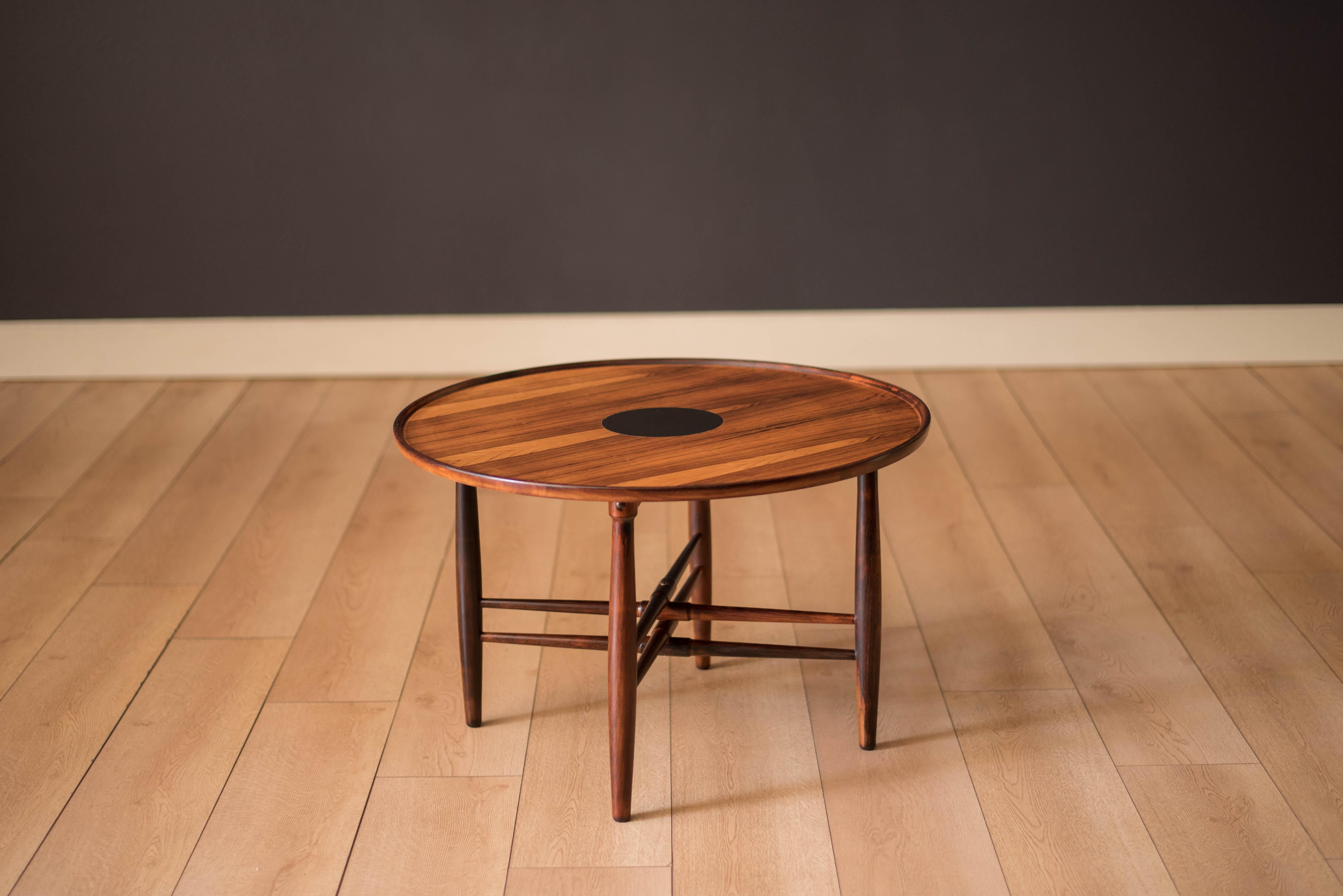 Mid-Century Modern round end table in rosewood designed by Poul Hundevad for Vamdrup Stolefabrik, Denmark. This occasional table features stunning rosewood grains and a unique black laminate insert convenient for resting drinks on. Supported by
