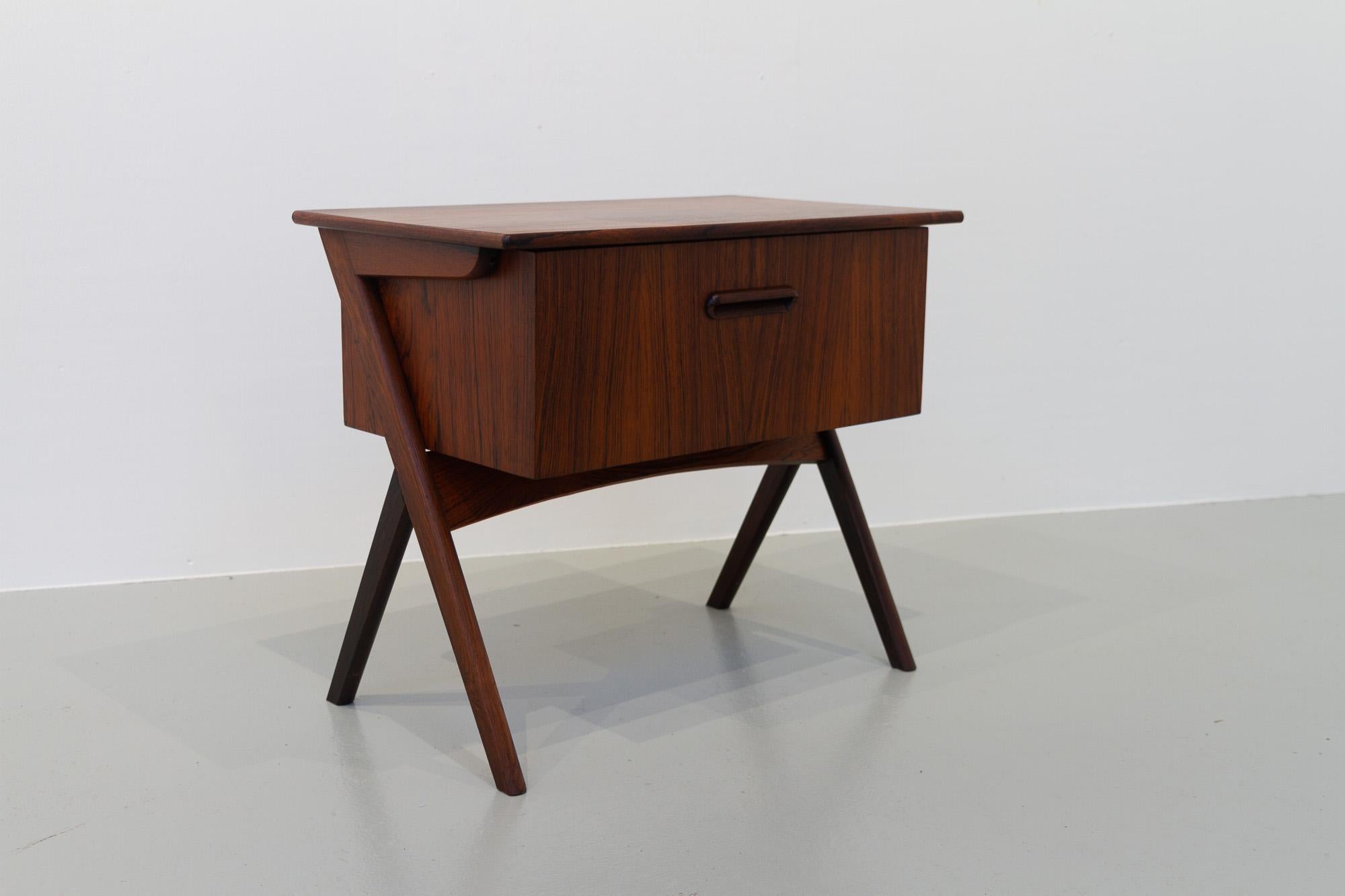 Vintage Danish Rosewood Sewing Table with Tilting Drawer, 1960s.
Elegant and versatile small table with scissor legs and pull out compartment in stunning rosewood veneer. Compartment contains two sliding trays.
Back in the 1960s sewing tables were