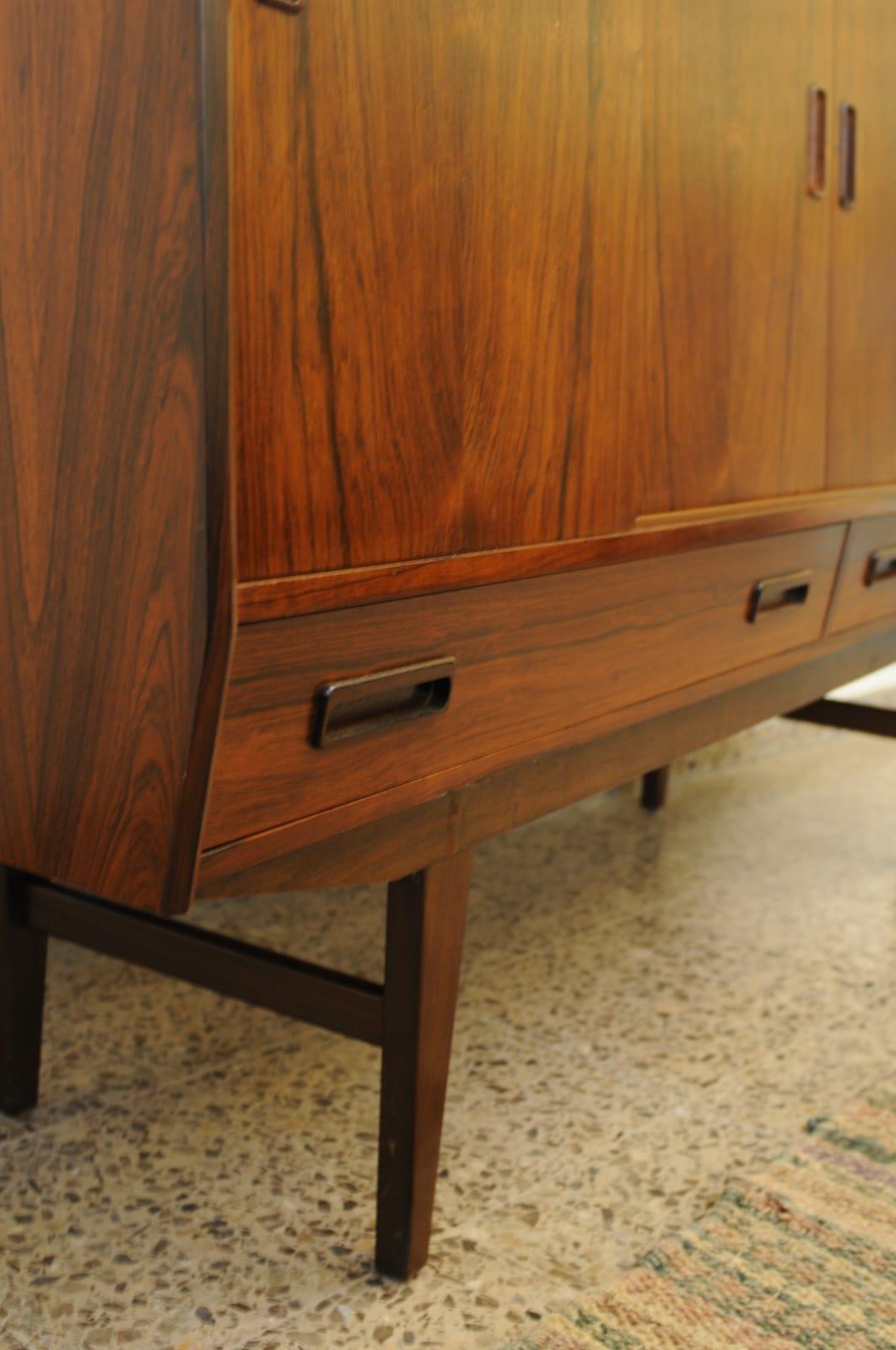 Rosewood sideboard designed by Borge Seindal in Denmark in the 1960s., gorgeous wood graining details and handles very unique of the era, In good condition throughout

This sideboard is an iconic example of Danish mid-century furniture in both