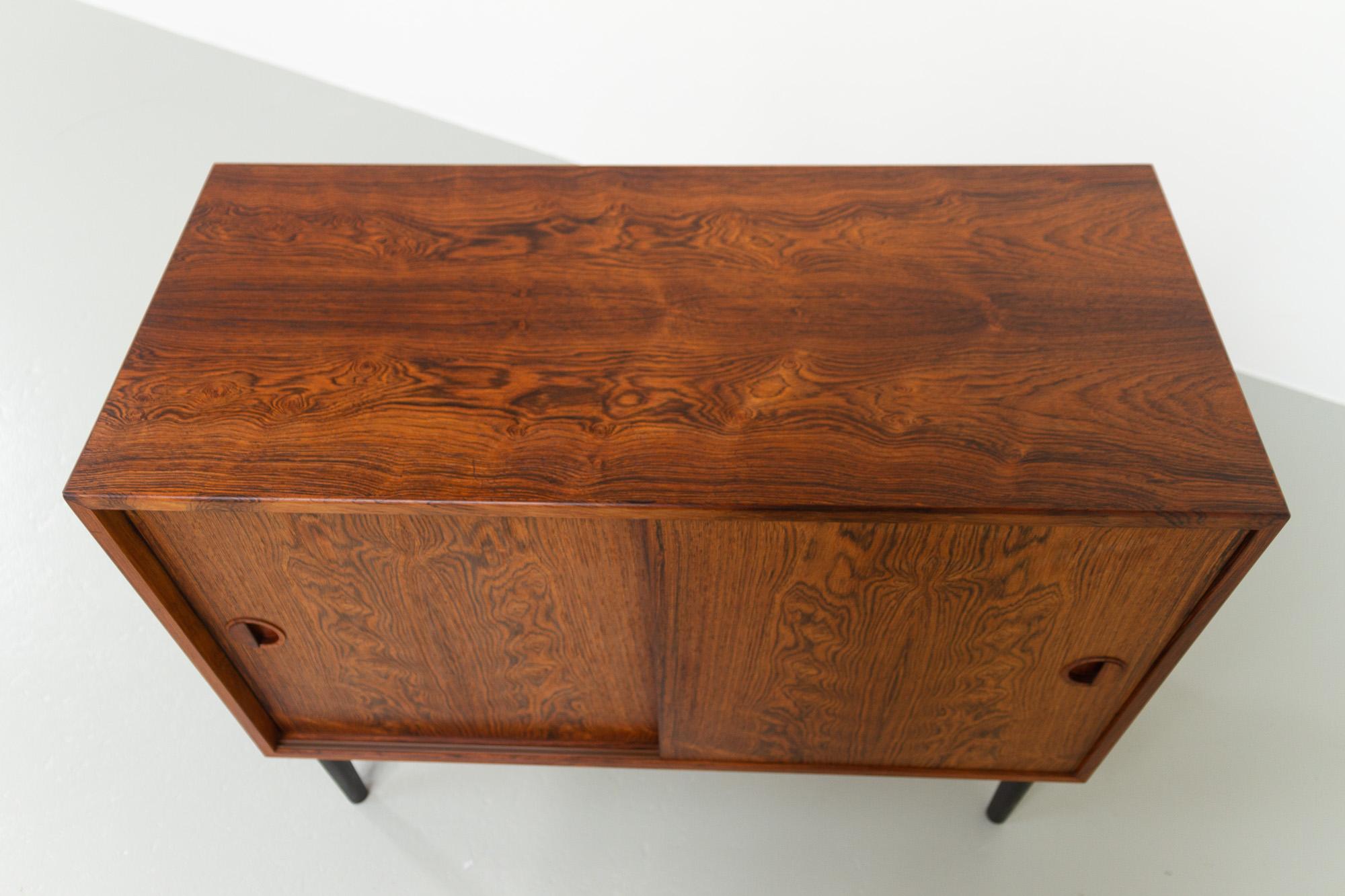 Vintage Danish Rosewood Sideboard with Sliding Doors by HG Furniture, 1960s.
Designed by Rud Thygesen og Johnny Sørensen for Hansen & Guldborg, Denmark.
This small mid-century modern Rosewood sideboard is part of the HG Wall unit system. The