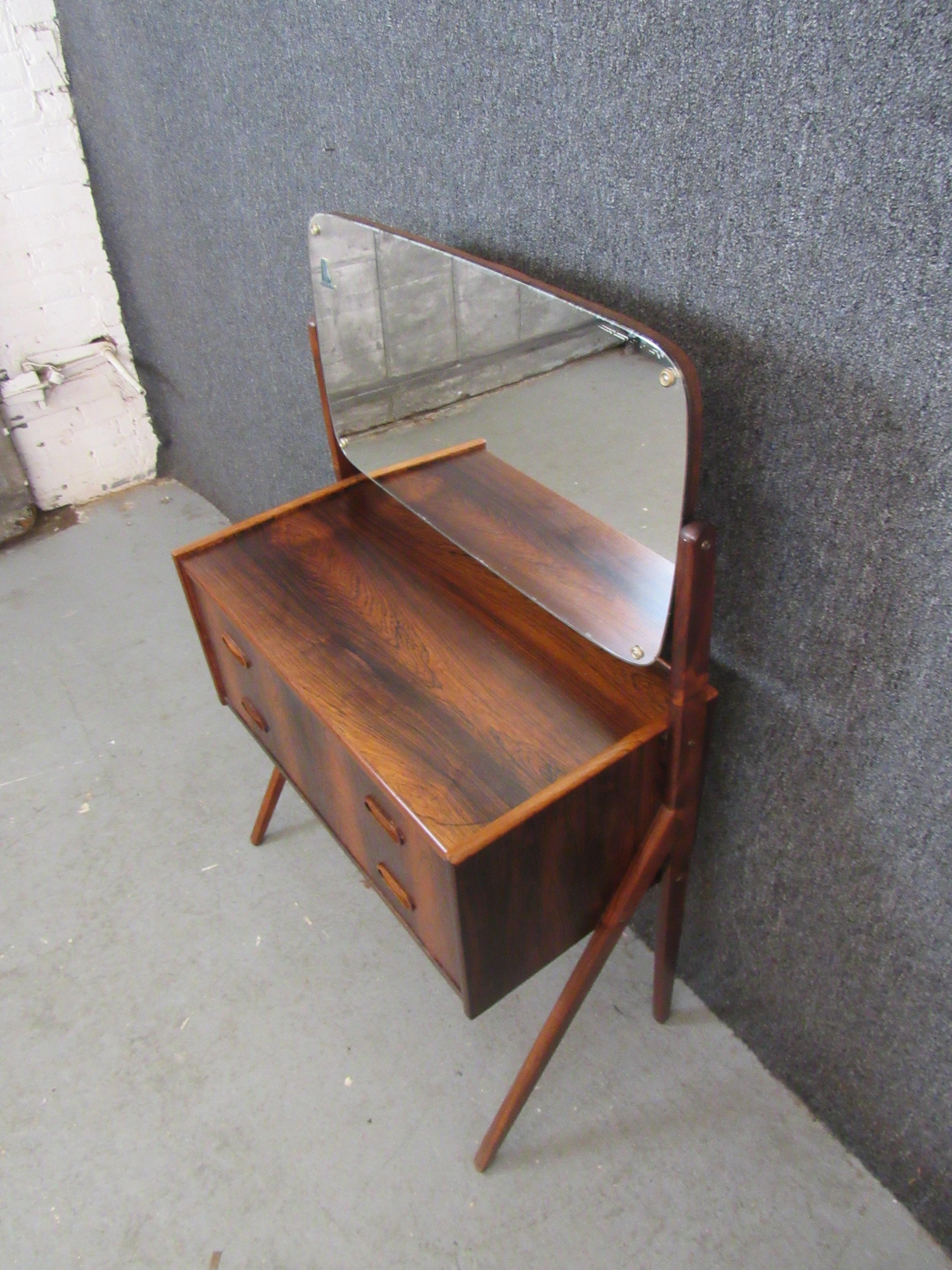 This stunning petite Danish rosewood vanity packs a big appearance into a compact package. Two sculpted wooden 