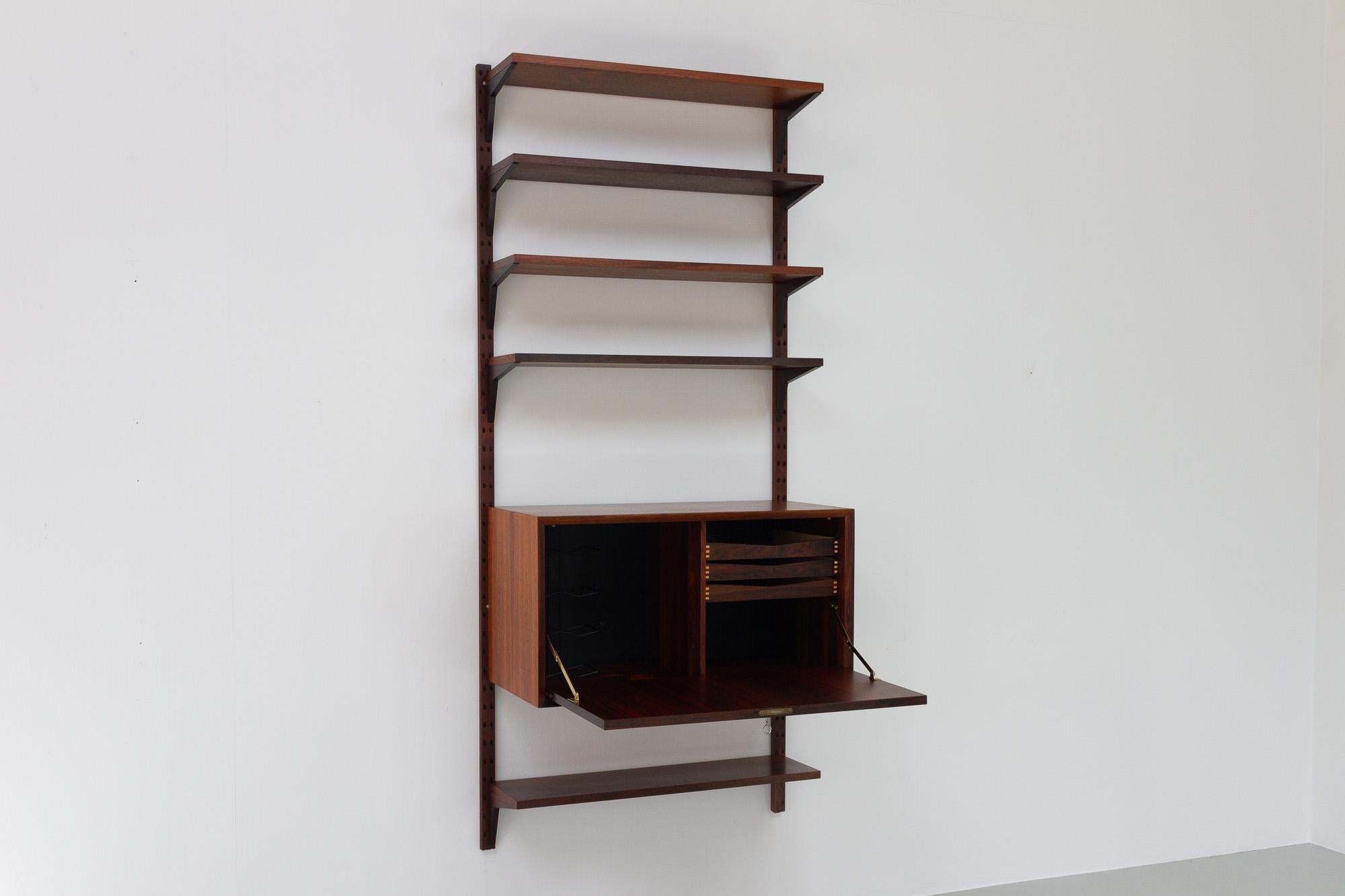 Vintage Danish Rosewood Wall Unit by Poul Cadovius for Cado 1960s.

Danish Mid-Century Modern 1 bay shelving system model Cado. This is a original vintage floating bookcase designed by Danish architect Poul Cadovius. 
Cadovius had the