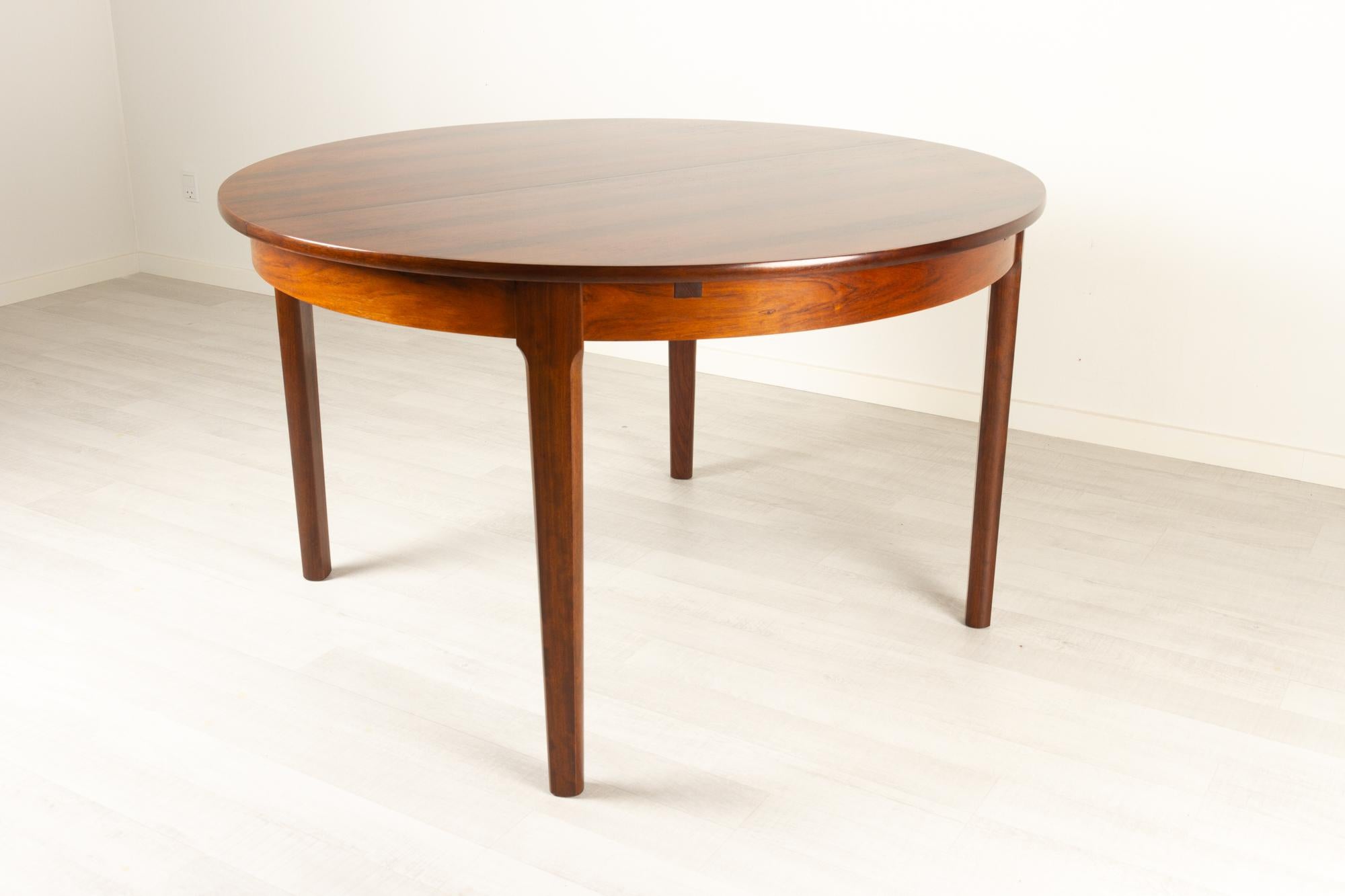 Vintage Danish round extendable rosewood dining table, 1960s
Danish modern round rosewood dining table with hidden double butterfly leaves. Extremely expressive and beautiful palisander grain pattern. Cleverly designed table where the extension