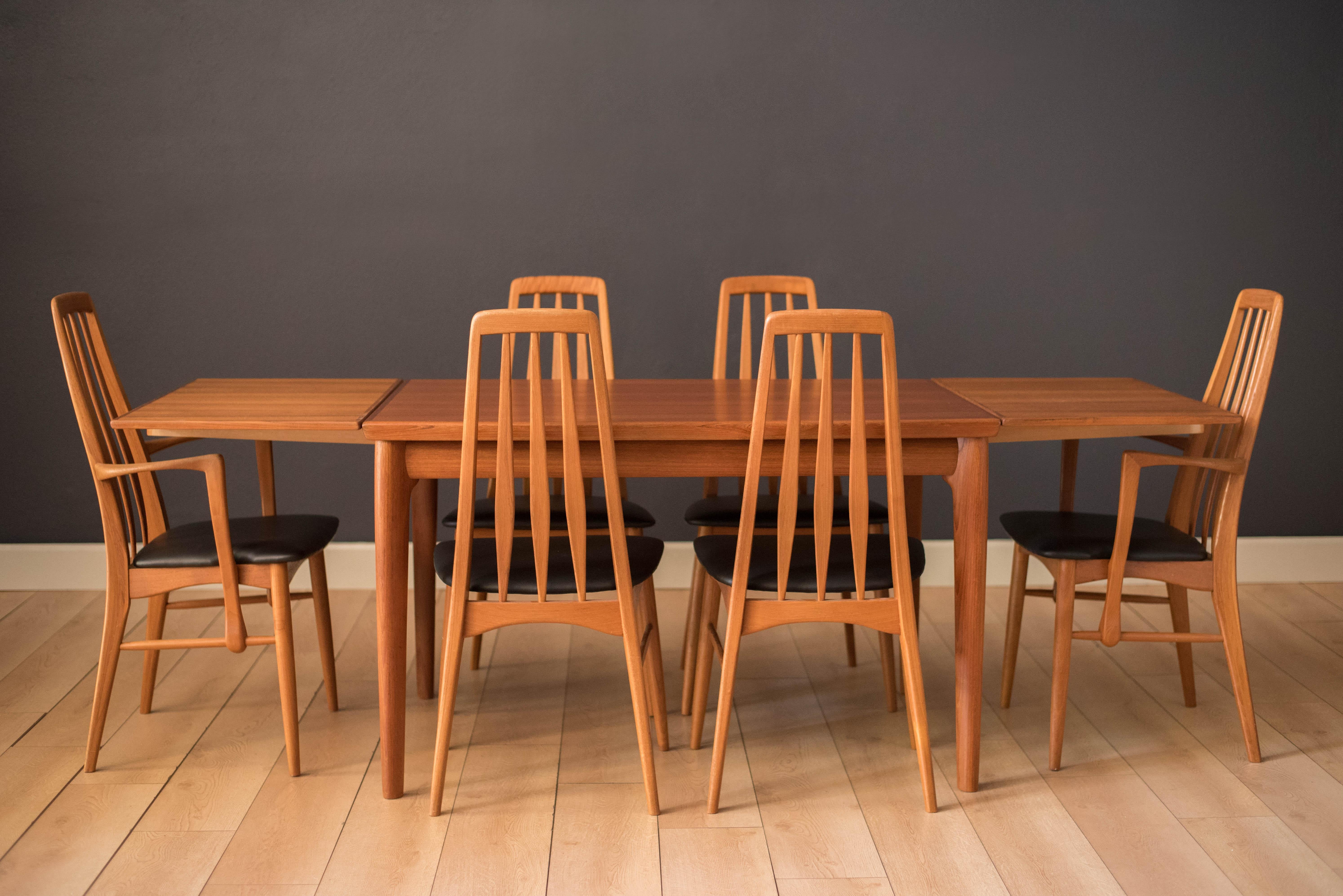 Mid-Century Modern 'Eva' dining chairs by Niels Koefoed for Hornslet Møbelfabrik. Features a sculptural teak frame designed with a tall backrest support. This set includes four side chairs and two captain armchairs. The seats have been newly